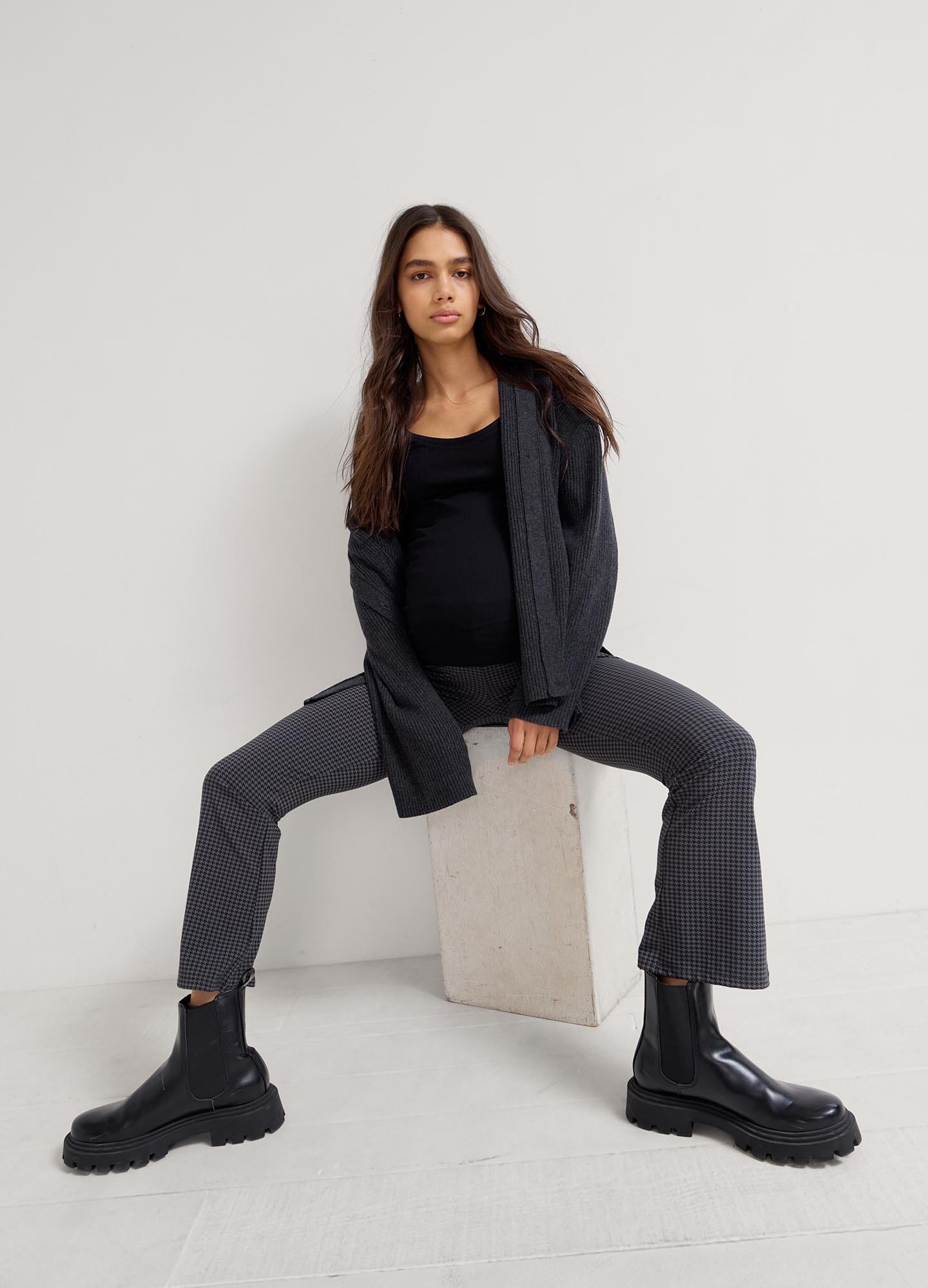 The Ultimate Before, During & After Crop Flare - Black maternity flare pants with side slits, designed for pregnancy, nursing, and postpartum.