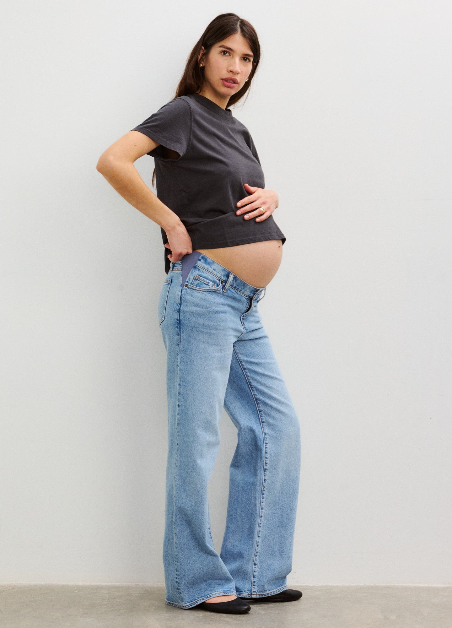 Light blue wide-leg maternity jeans with relaxed fit designed for pregnant women, paired with a black fitted t-shirt.