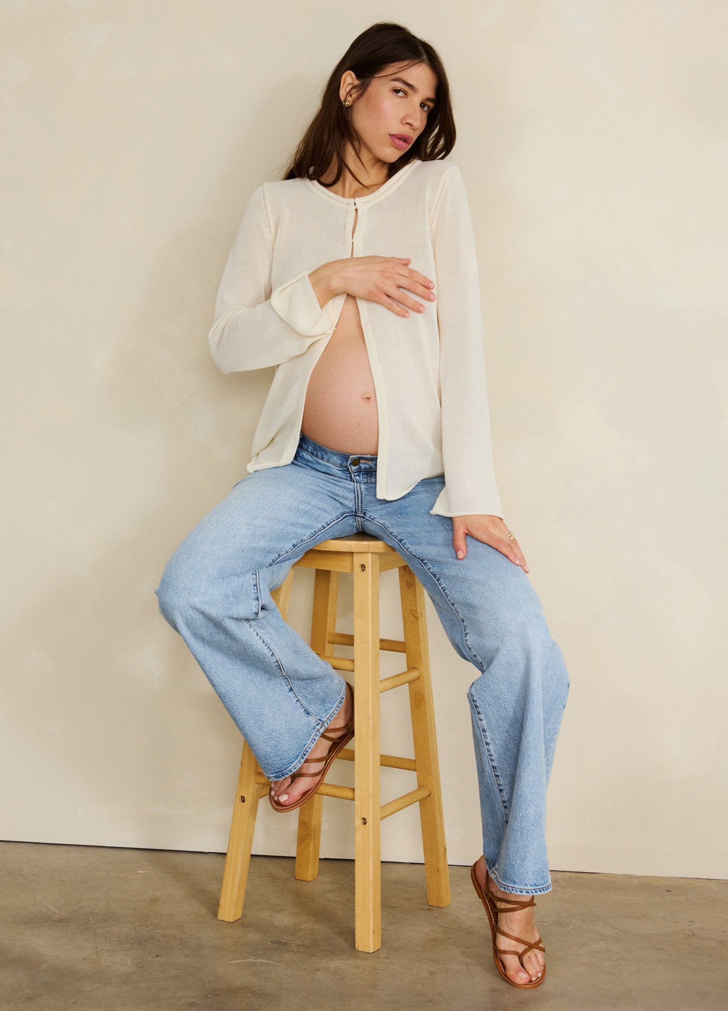 Light blue wide-leg maternity jeans with relaxed fit and full-length style.