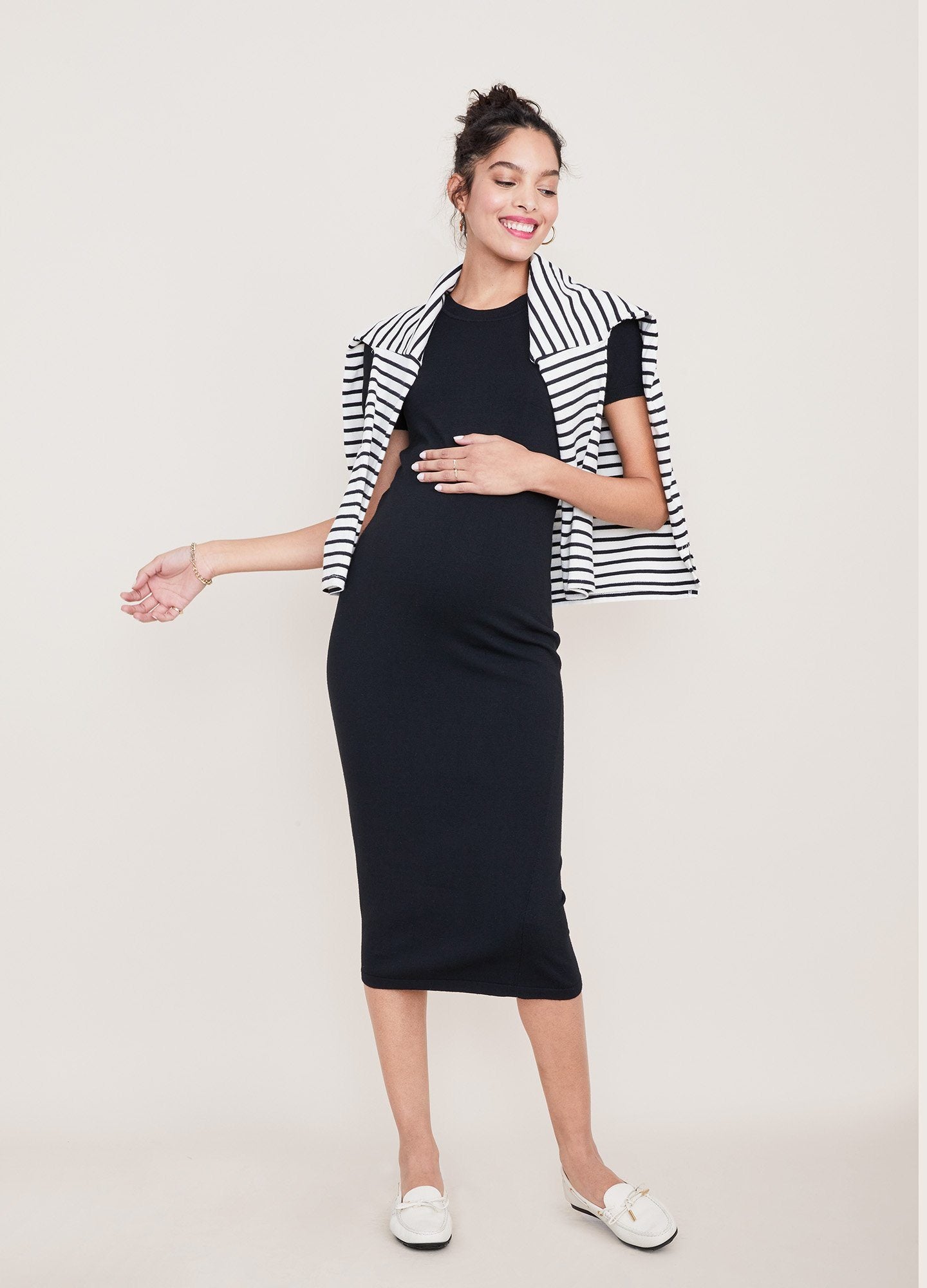 The Eliza Dress POS - Black short-sleeve maternity dress with nursing-friendly design and fitted silhouette, styled with tall black boots.