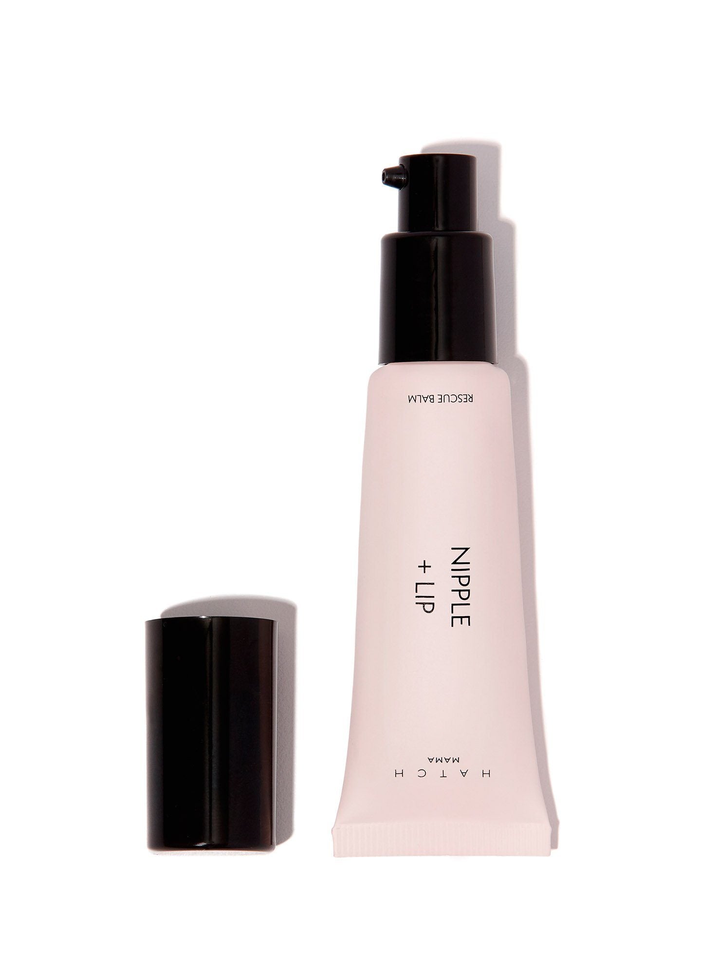 Nipple + Lip Rescue Balm - Nipple + Lip Rescue Balm in soft pink tube with black cap beside matching box, designed for maternity, pregnancy, nursing,.