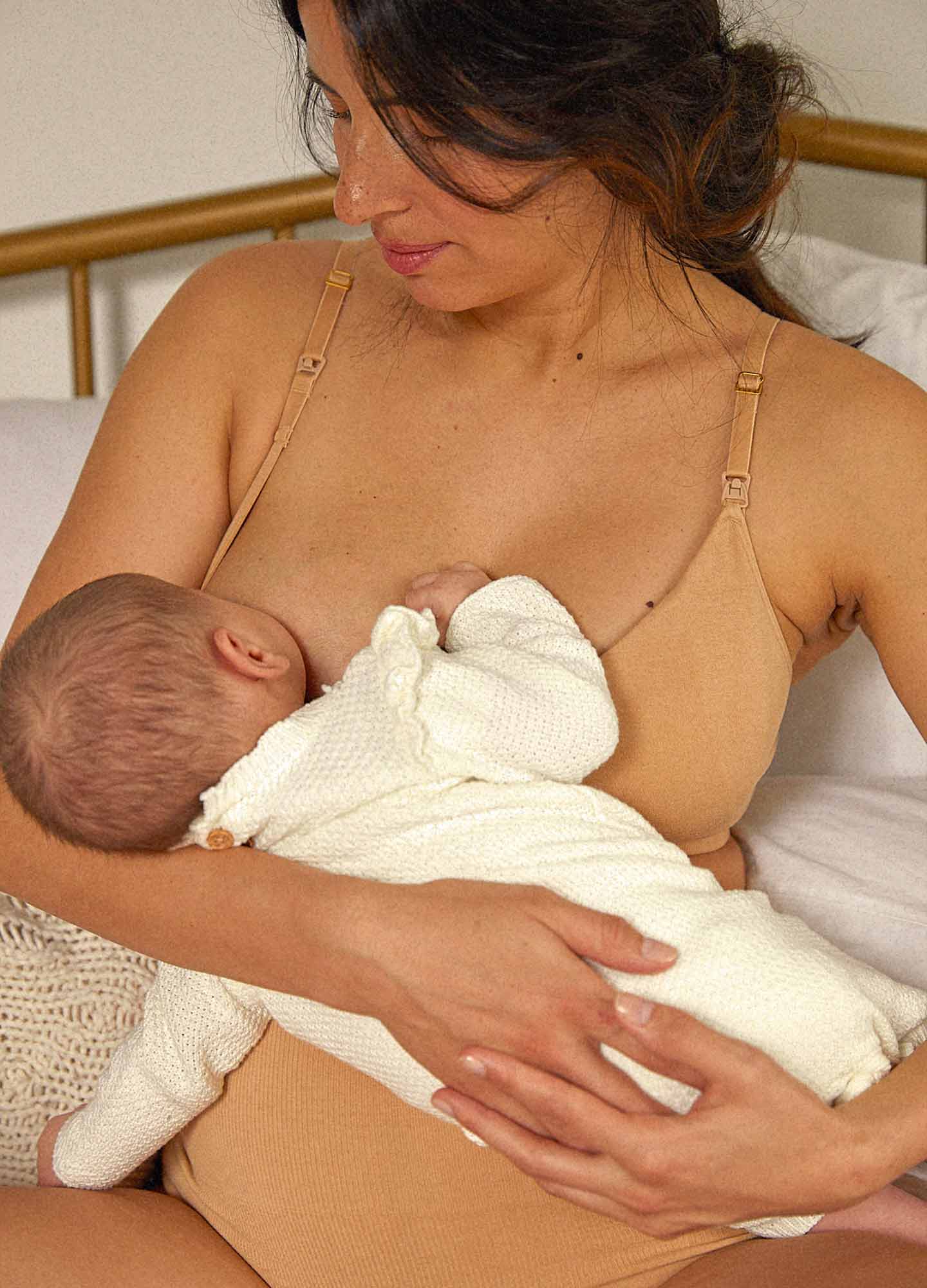 The Essential Nursing And Pumping Bra - Sand-colored maternity bra with adjustable straps designed for nursing and postpartum comfort.