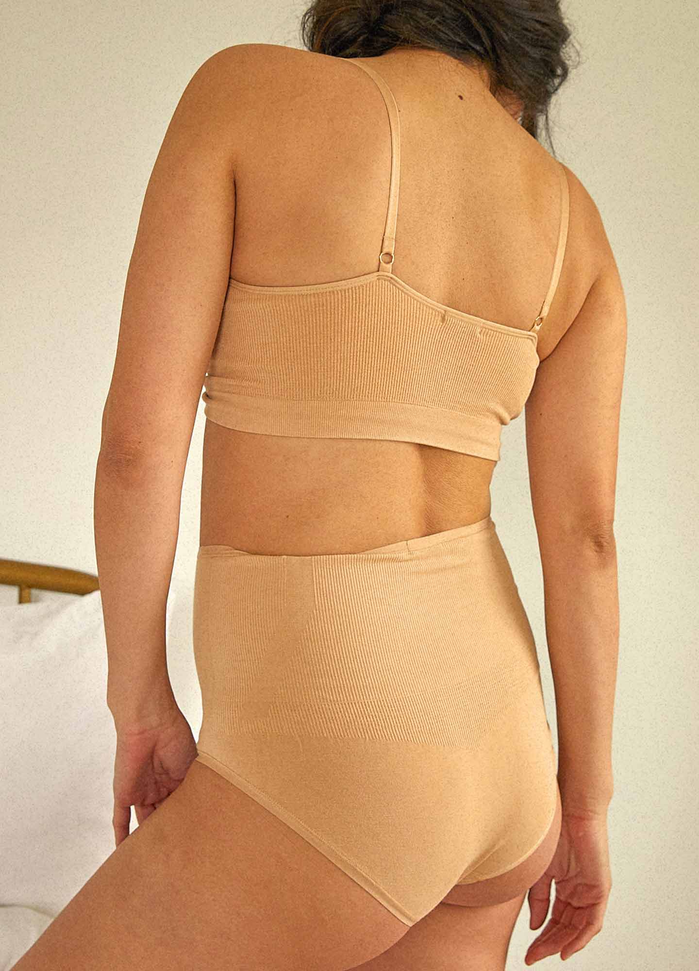 The Essential Nursing And Pumping Bra - Sand-colored maternity bra with adjustable straps designed for nursing and postpartum comfort.