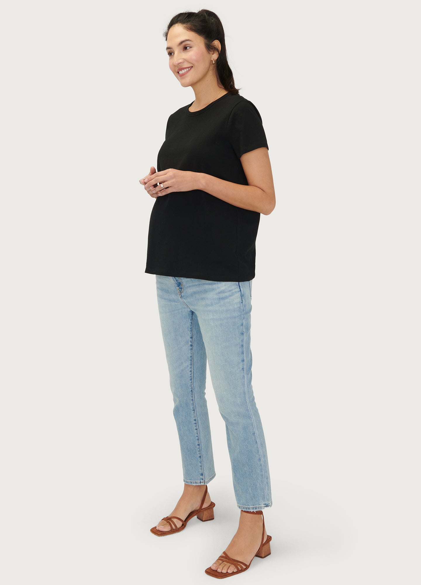 The Basic Crew Tee 2-Pack - Black maternity nursing crew tee with short sleeves and curved hem, modeled with light blue jeans.