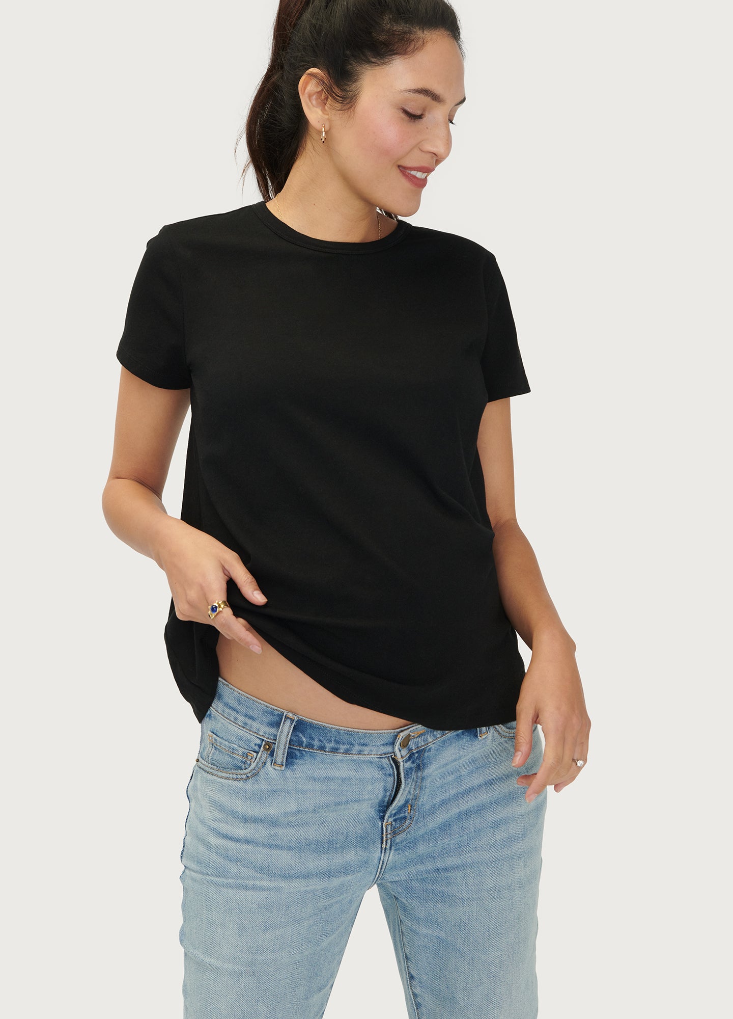 The Basic Crew Tee 2-Pack - Black maternity nursing crew tee with short sleeves and curved hem, modeled with light blue jeans.