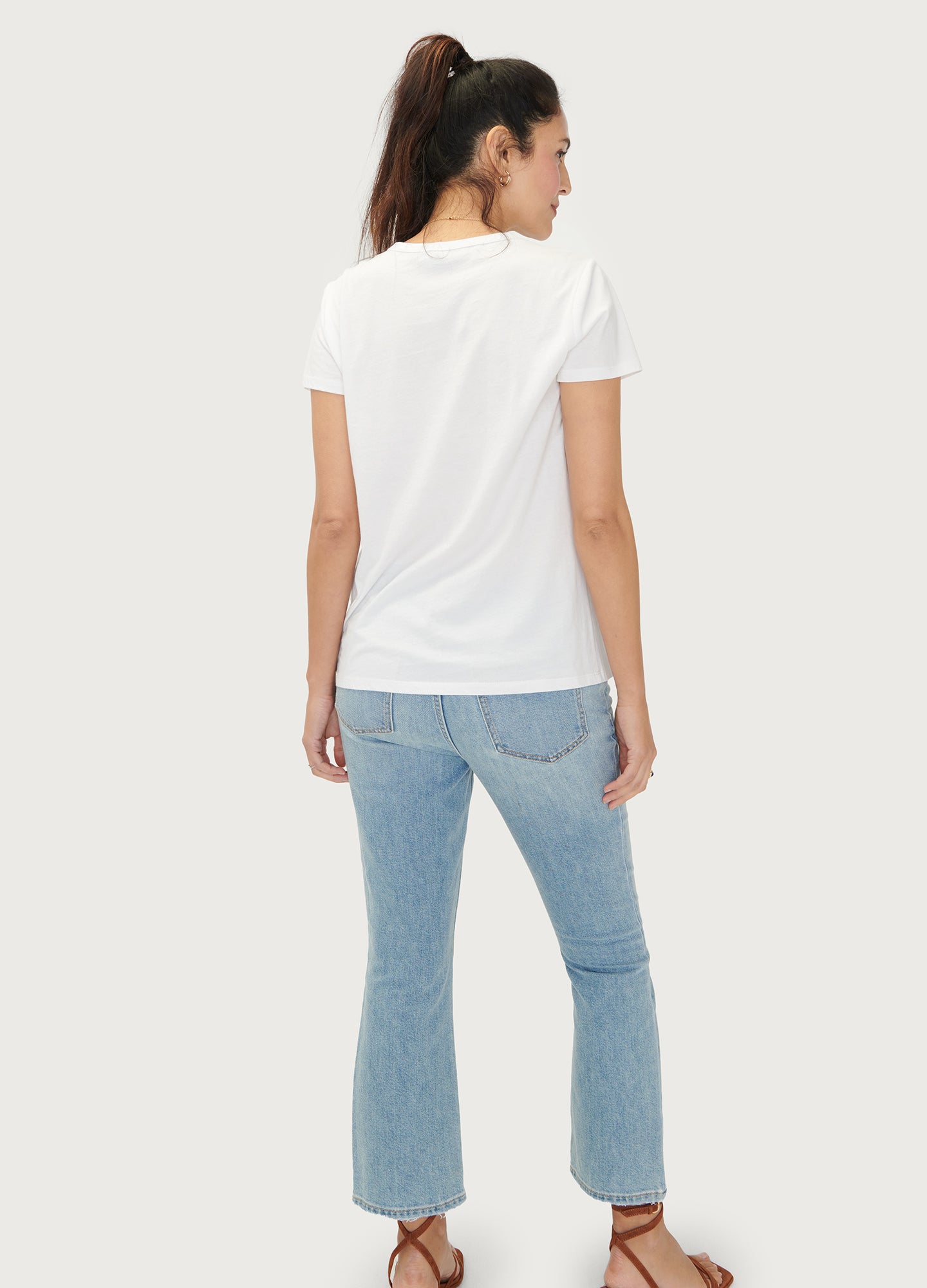 The Basic Crew Tee 2-Pack - Black maternity nursing crew tee with short sleeves and curved hem, modeled with light blue jeans.