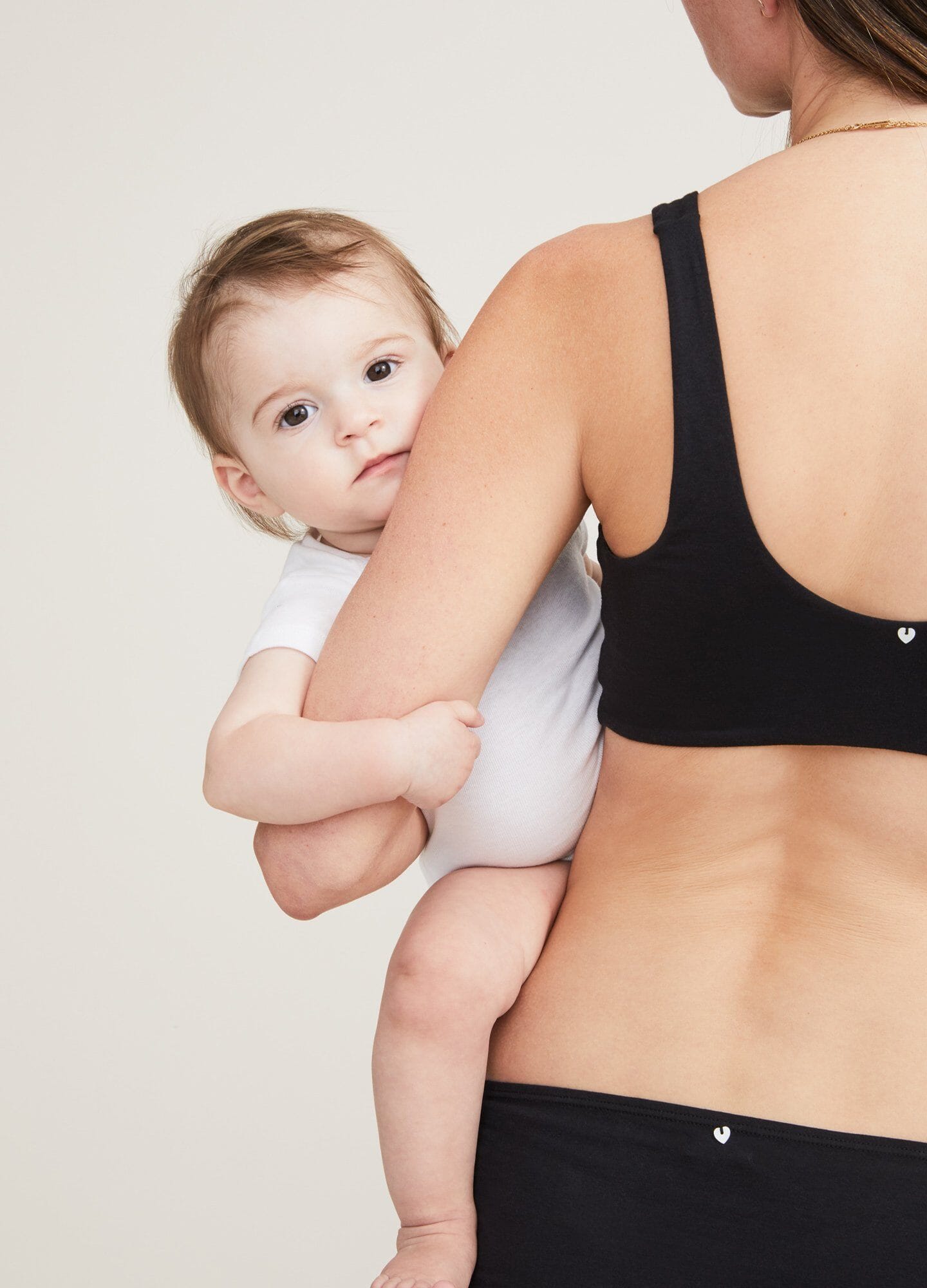 Black seamless maternity bra with wide adjustable straps and smooth back band.