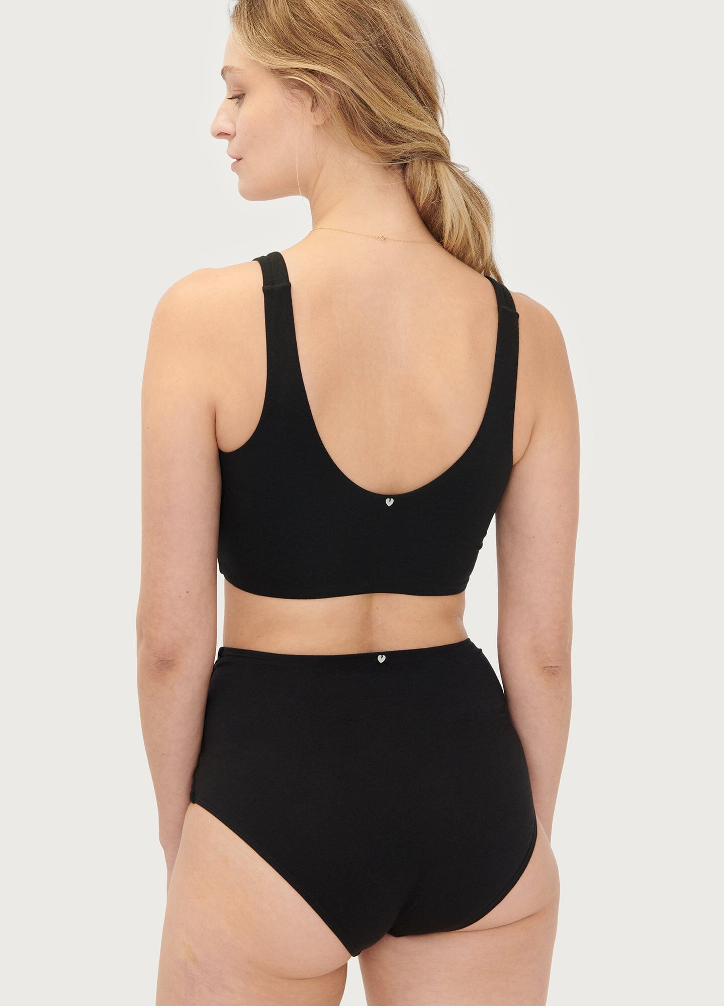 Black seamless maternity bra with wide straps and soft, stretchy fabric designed for comfort during pregnancy.