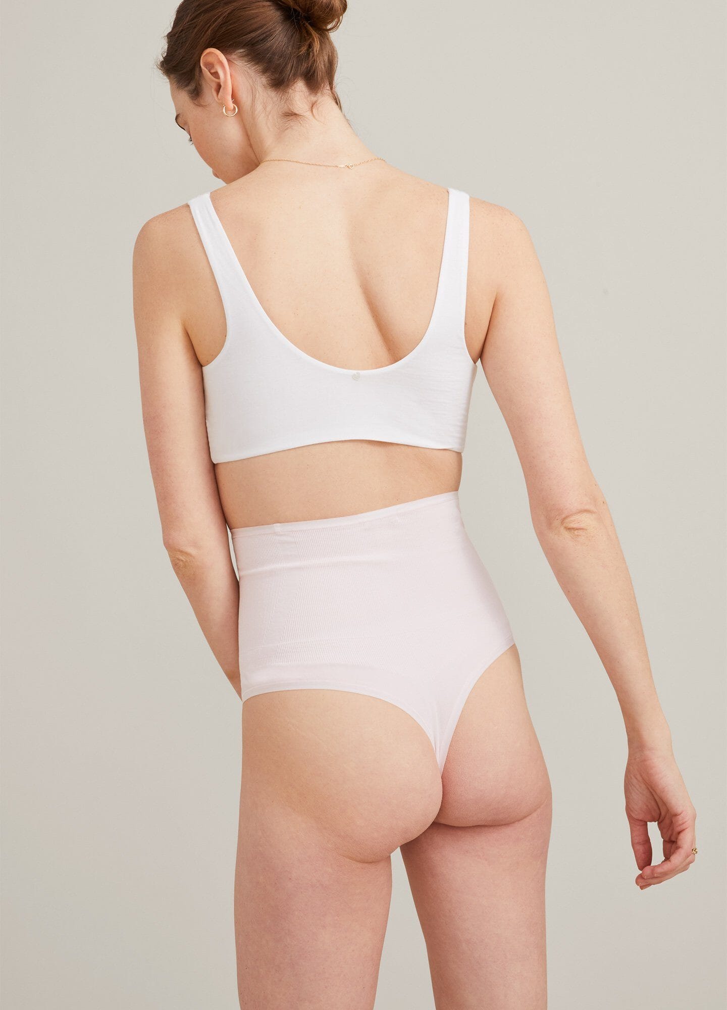 White maternity bra with wide supportive straps and smooth, seamless back design.
