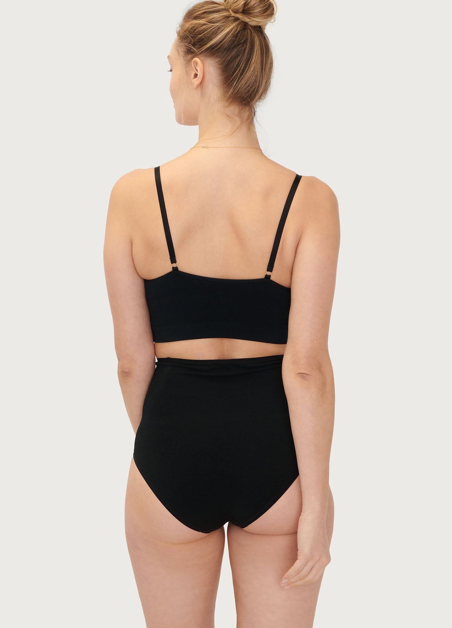 The Essential Nursing And Pumping Bra - Black maternity nursing bra with adjustable straps, soft seamless fabric for pregnancy and postpartum comfort.