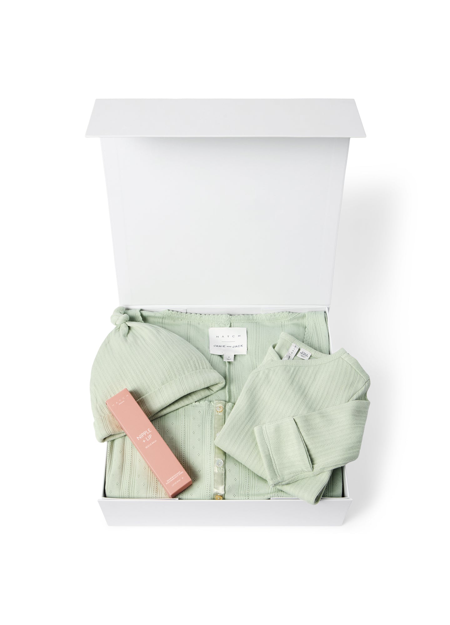 Open white gift box with sage green maternity loungewear set and pink baby bottle inside.
