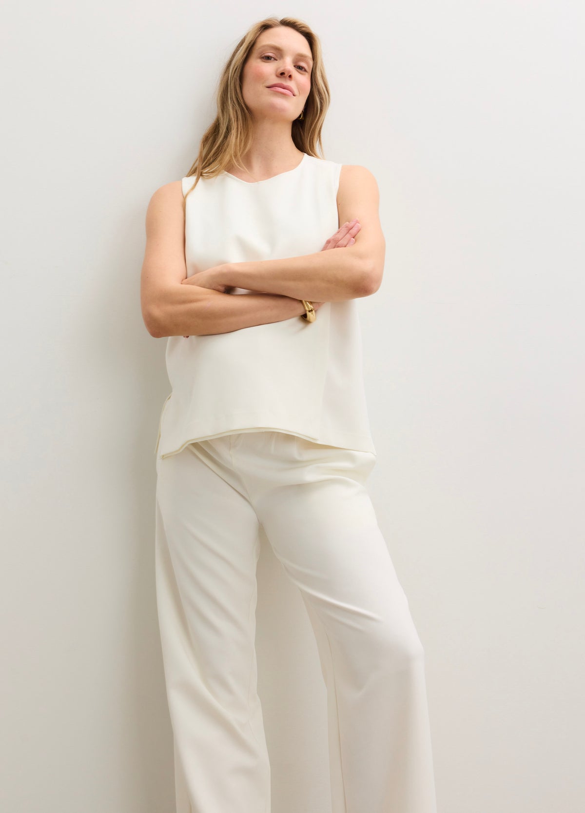 Cream-colored maternity pants with a relaxed, wide-leg fit and a smooth, stretchy waistband designed for pregnancy comfort.