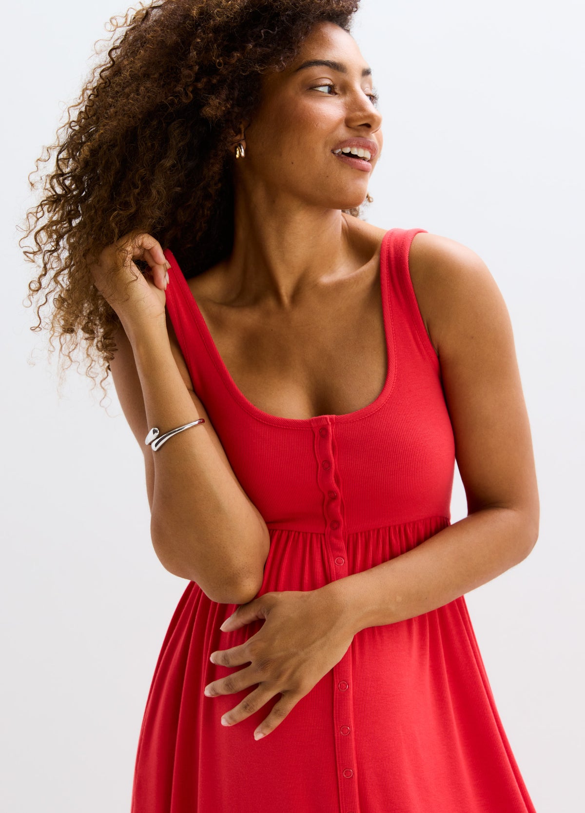 Red ribbed nursing tank dress with button-front detail and fitted empire waist, sleeveless and knee-length.