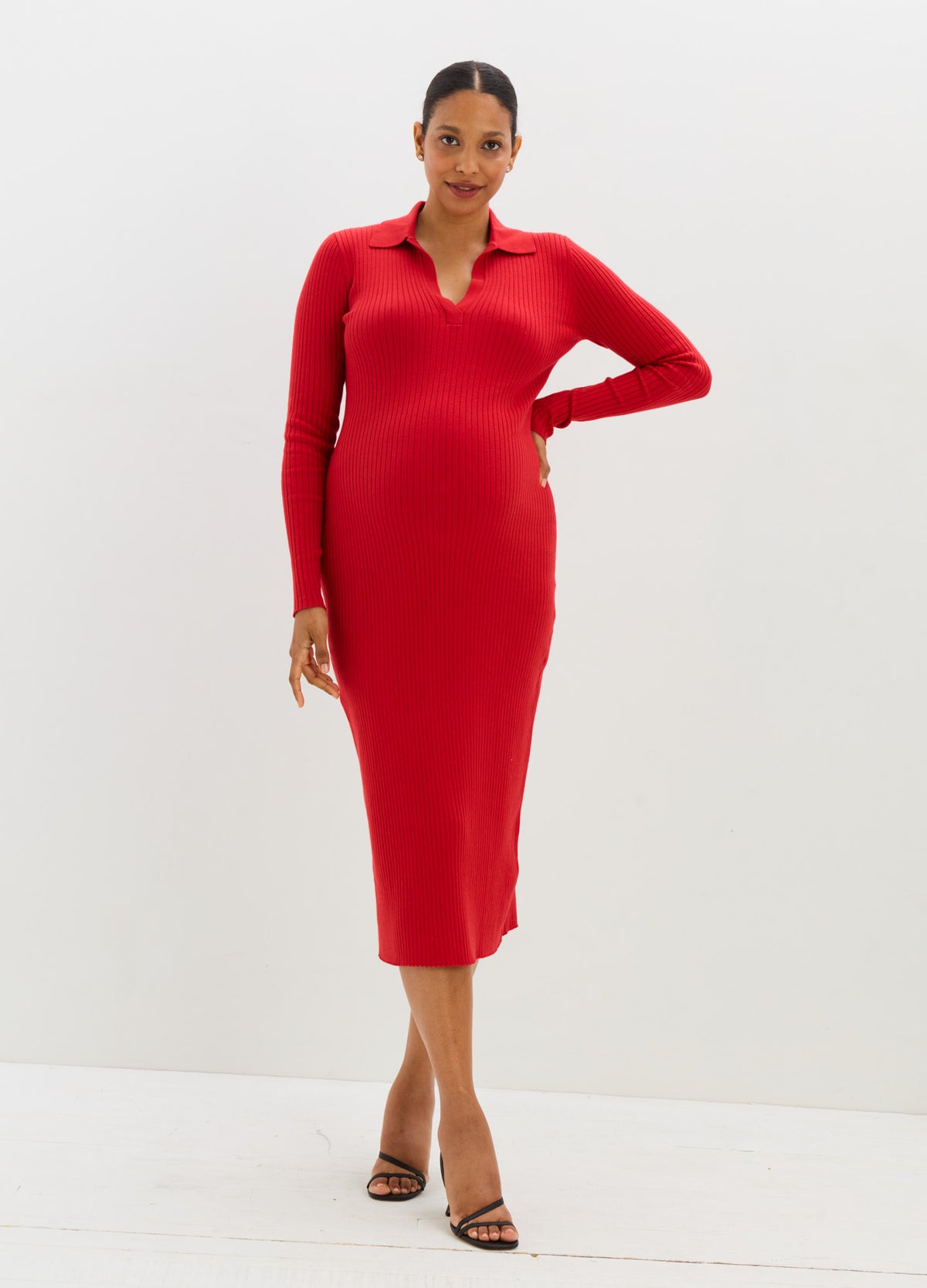 Red long-sleeve ribbed knit maternity sweater dress with collar and midi length.