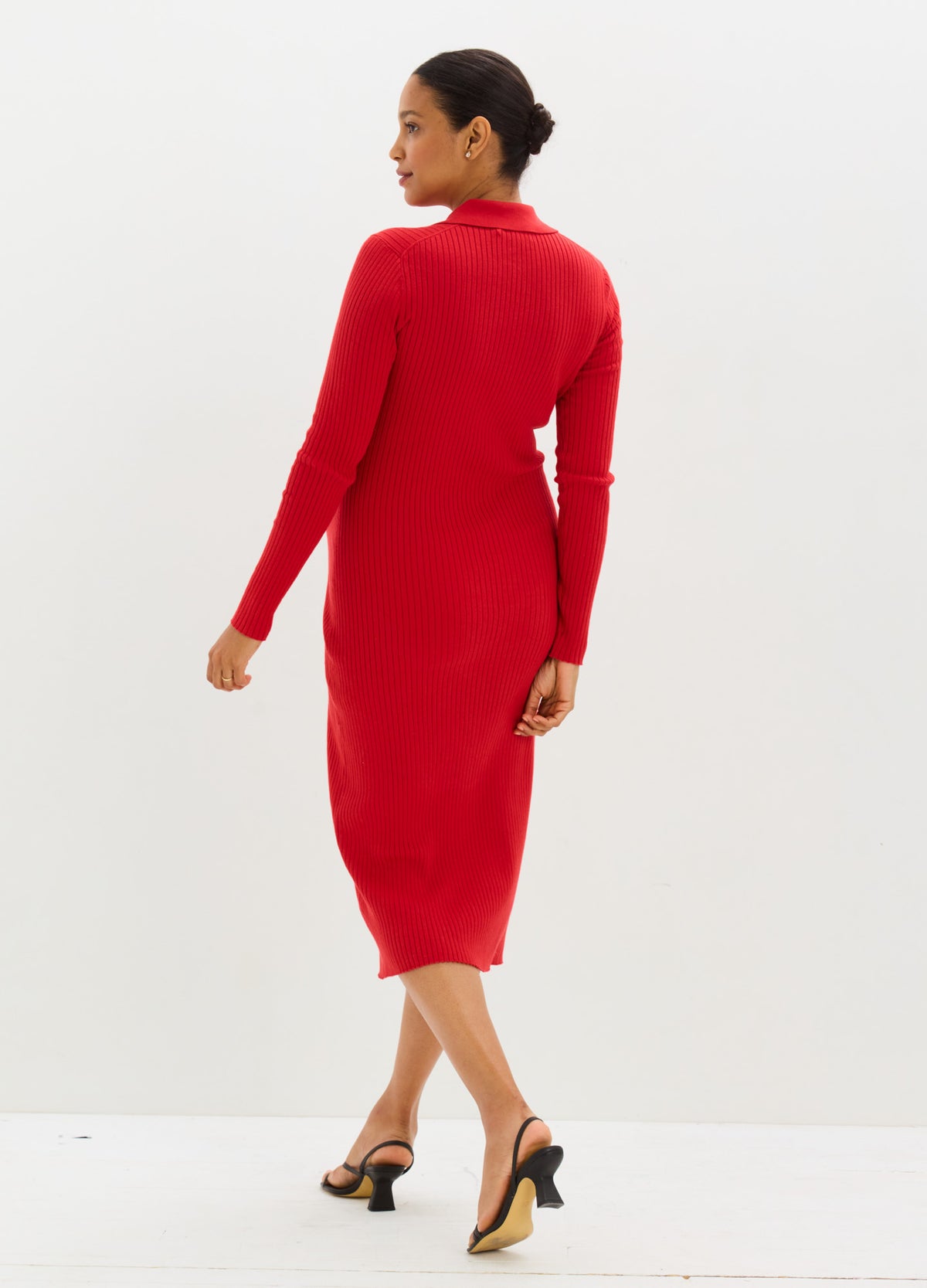 Red, ribbed knit maternity sweater dress with long sleeves and midi length, fitted silhouette.