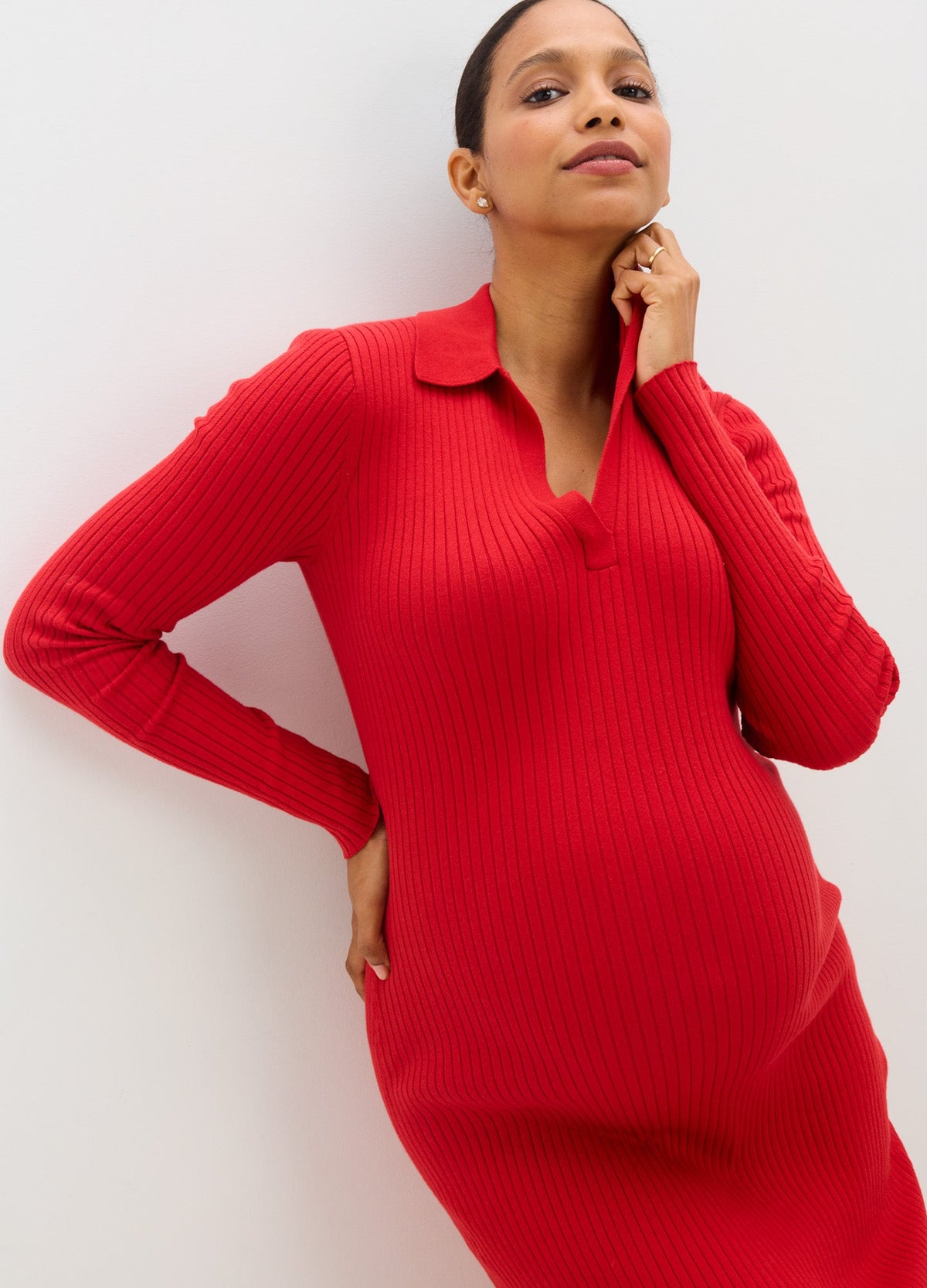Bright red ribbed maternity sweater dress with a fitted long-sleeve silhouette and quarter-zip collar.