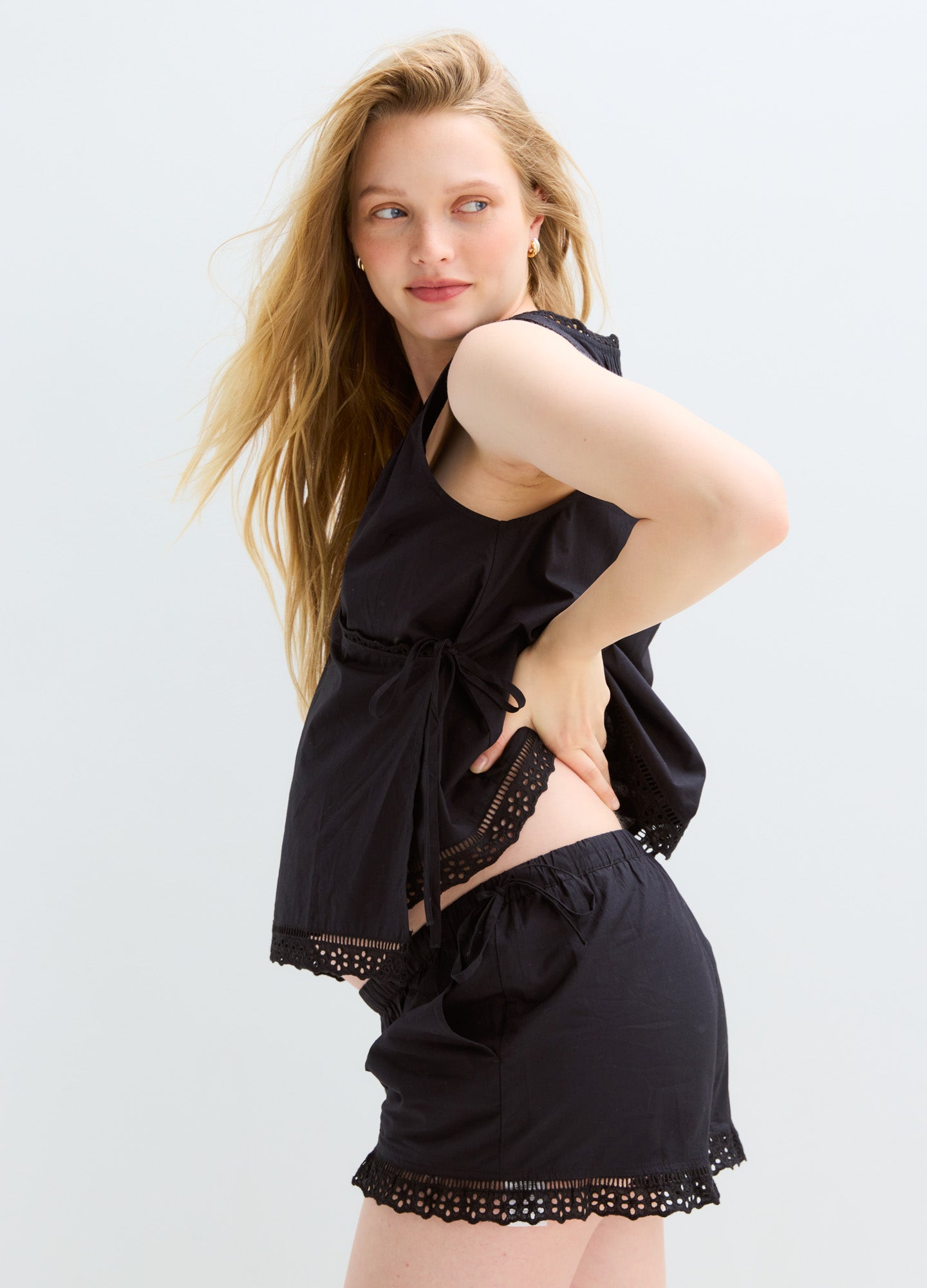 Black maternity shorts and sleeveless top set with lace trim, lightweight fabric designed for pregnancy comfort.