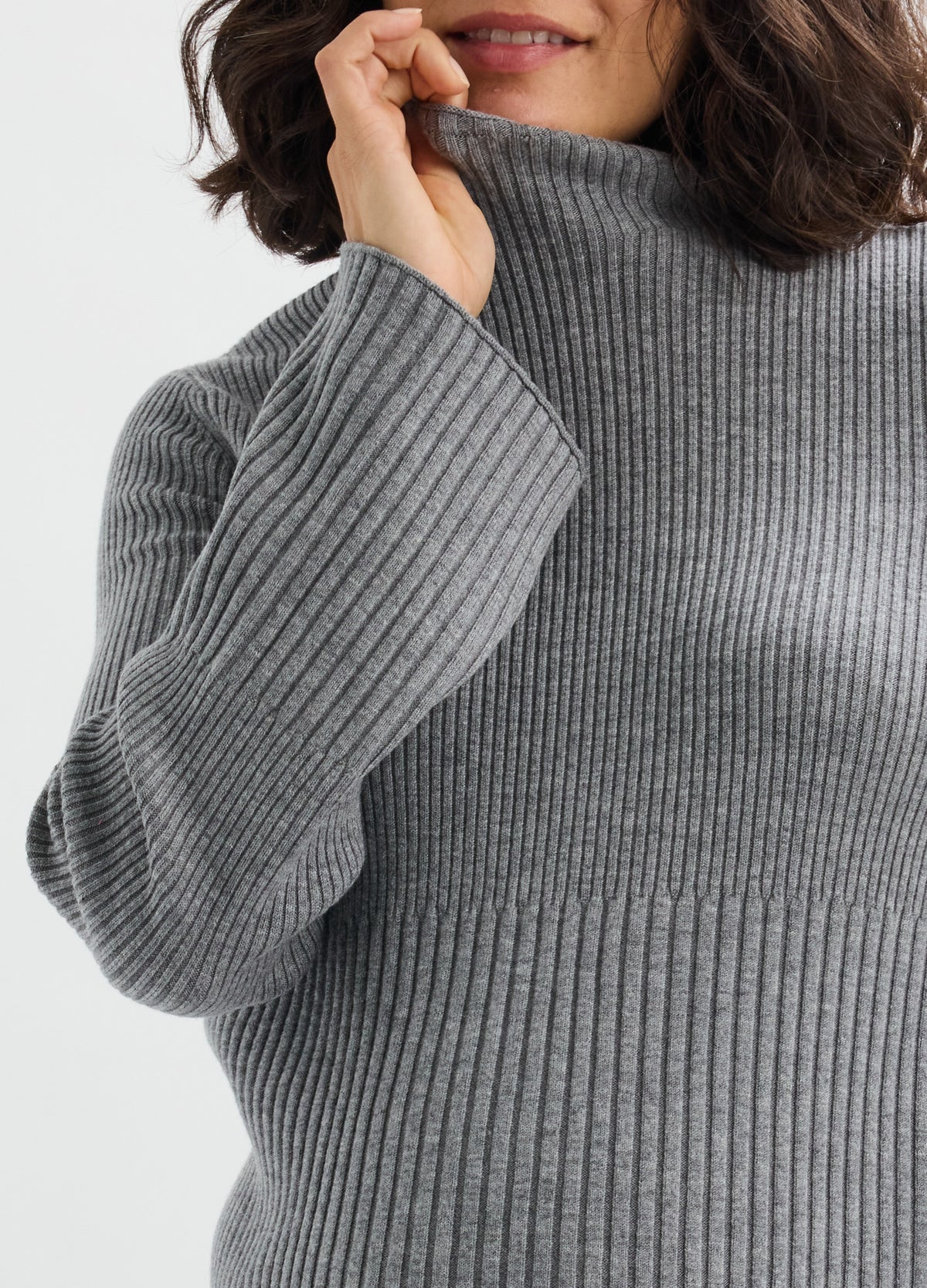 Gray ribbed knit turtleneck sweater with long sleeves and a relaxed fit designed for maternity wear.