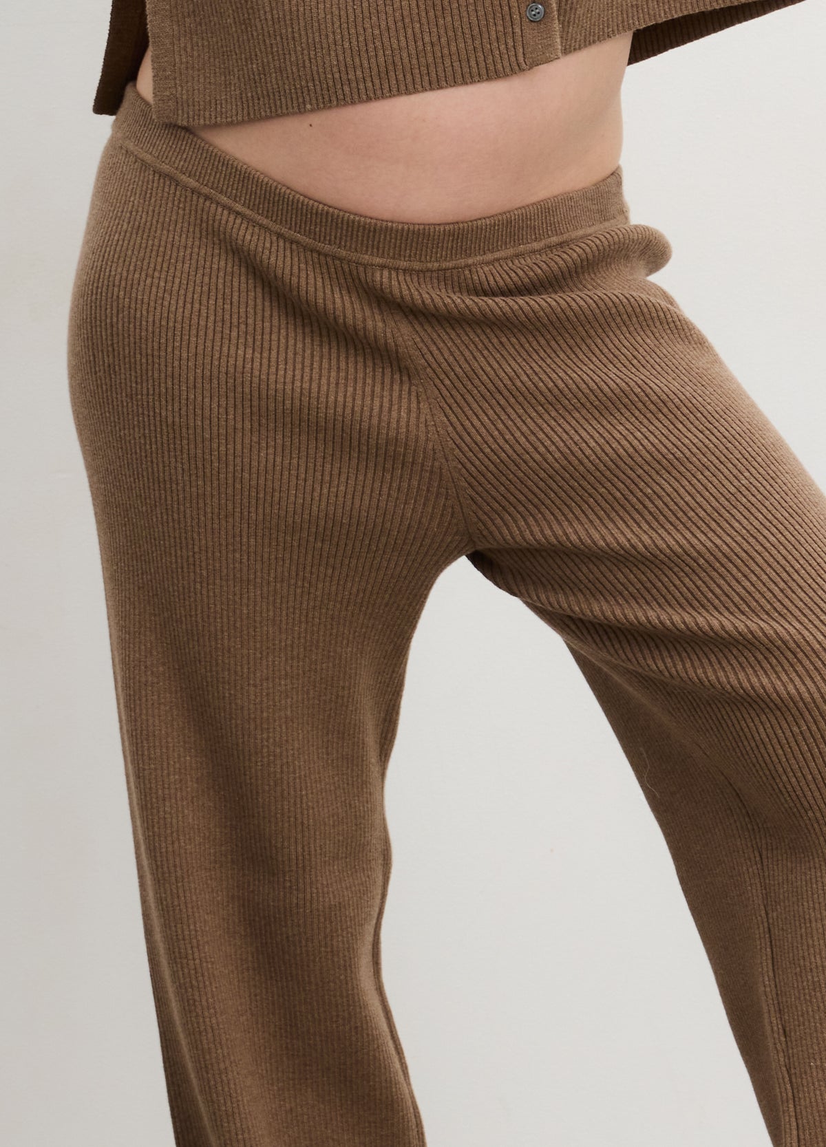 Brown ribbed knit maternity pants with a soft stretch waistband for pregnant comfort.