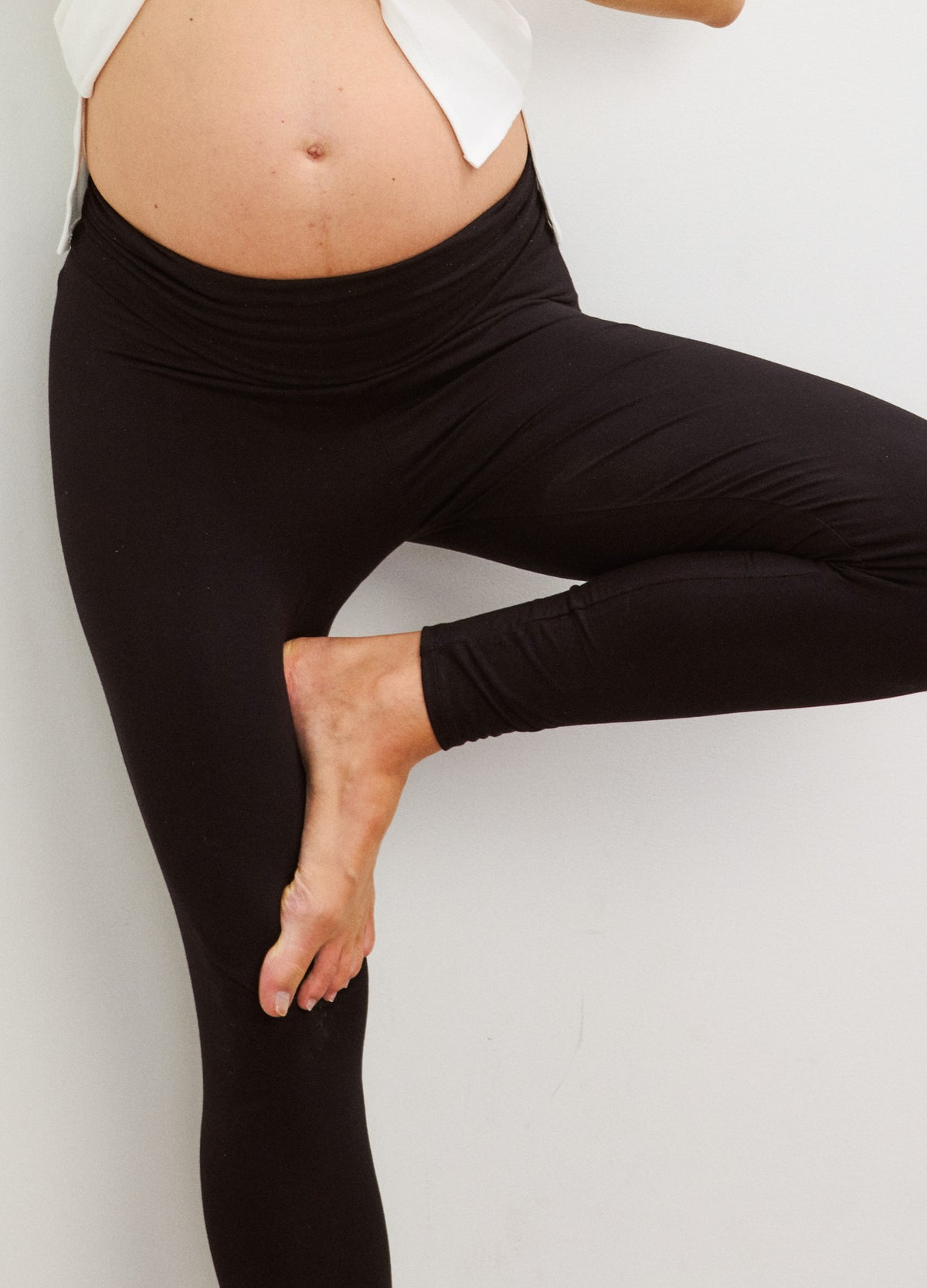 Black maternity leggings with high supportive waistband, stretchy soft fabric designed for pregnancy comfort.