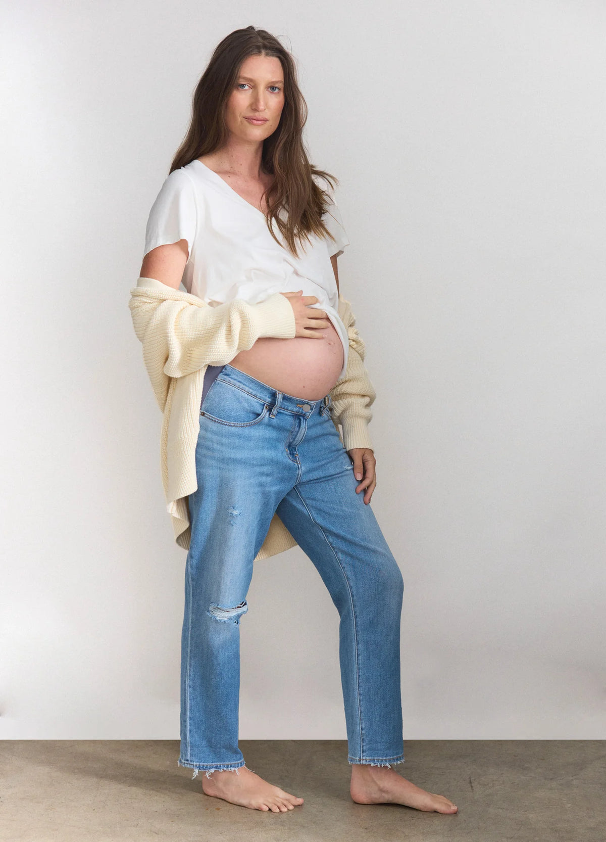 Light blue relaxed-fit boyfriend maternity jeans with stretch fabric and slight distressing.