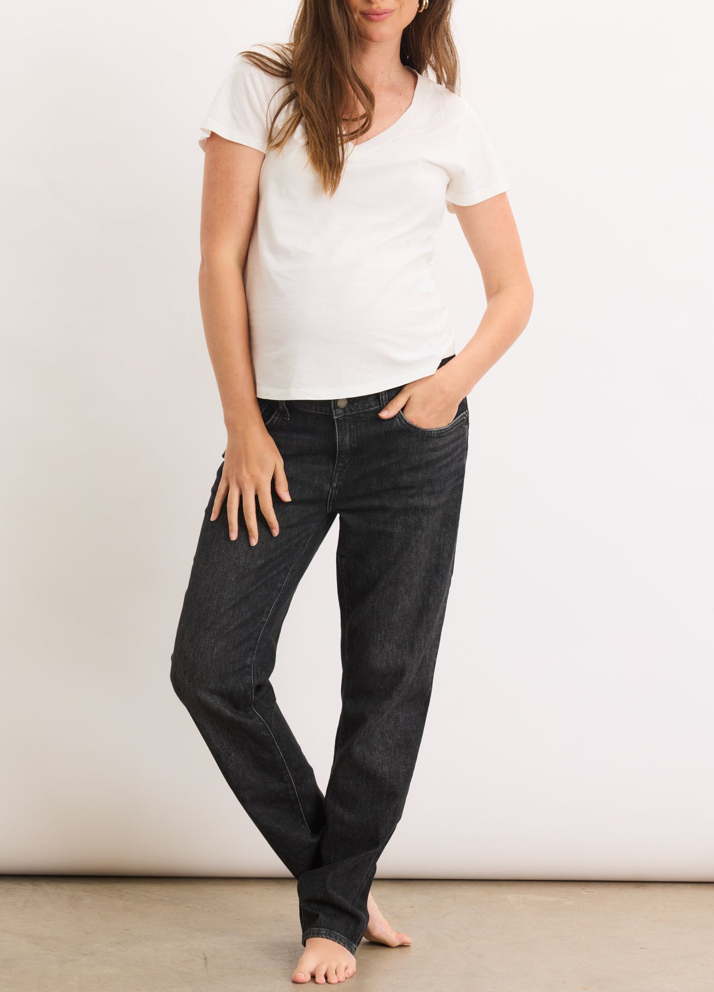 Dark wash blue denim maternity boyfriend jeans with a relaxed fit and stretch waistband.