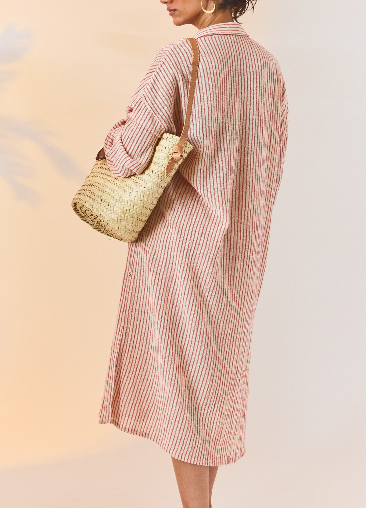 Red and natural striped maternity shirt dress with long sleeves and relaxed fit, styled on pregnant model.