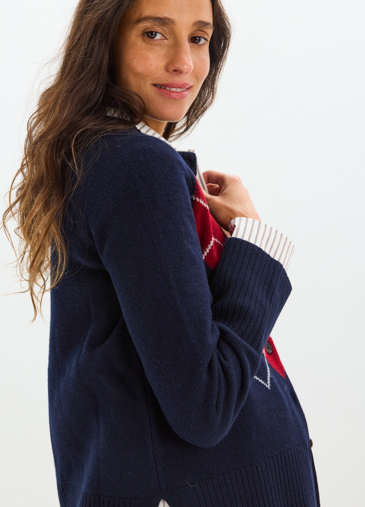 Navy blue maternity cardigan with long sleeves and ribbed cuffs worn by pregnant woman.
