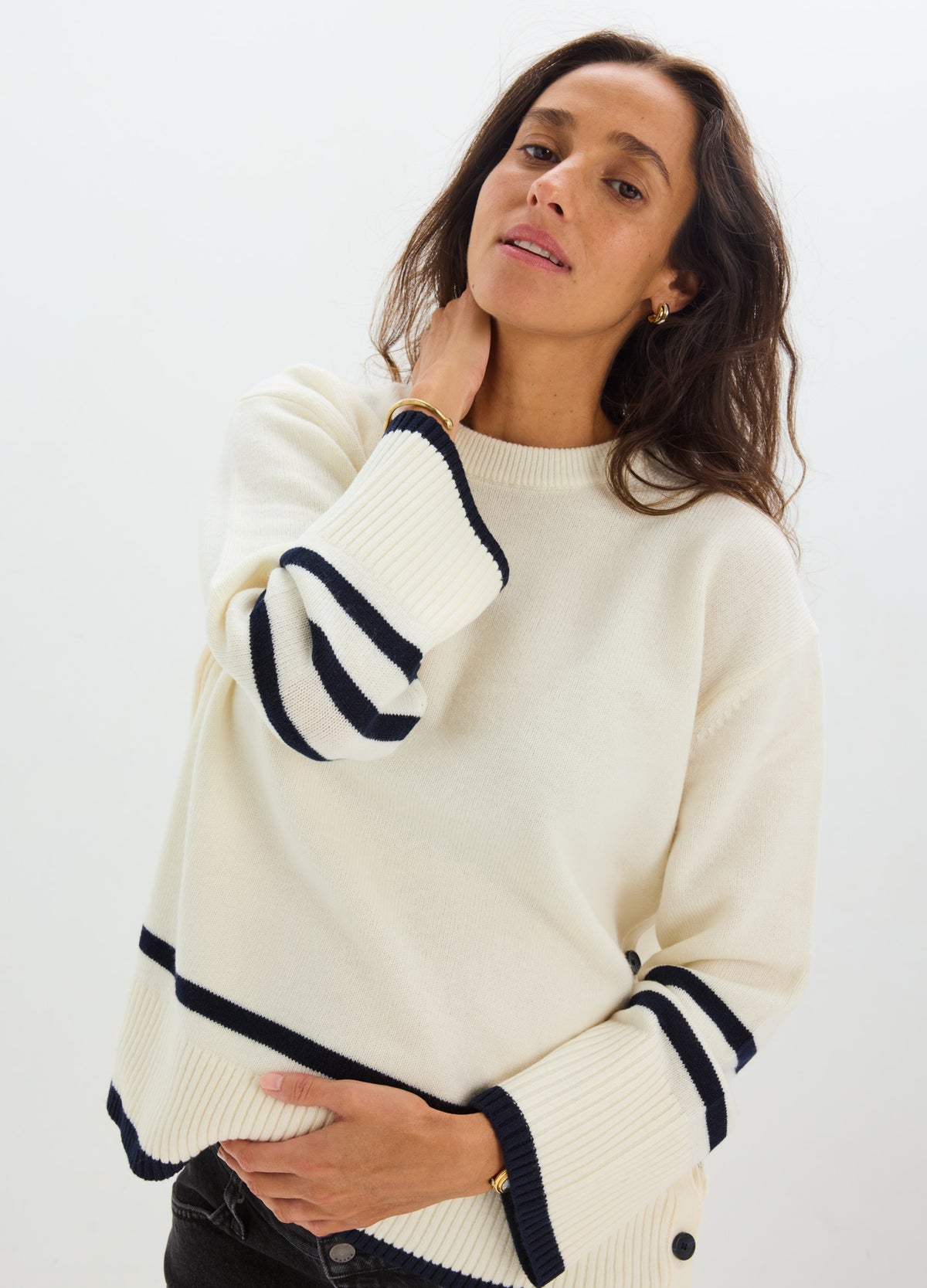 Cream-colored maternity nursing sweater with navy stripe details on sleeves and hem, soft knit fabric, relaxed fit.