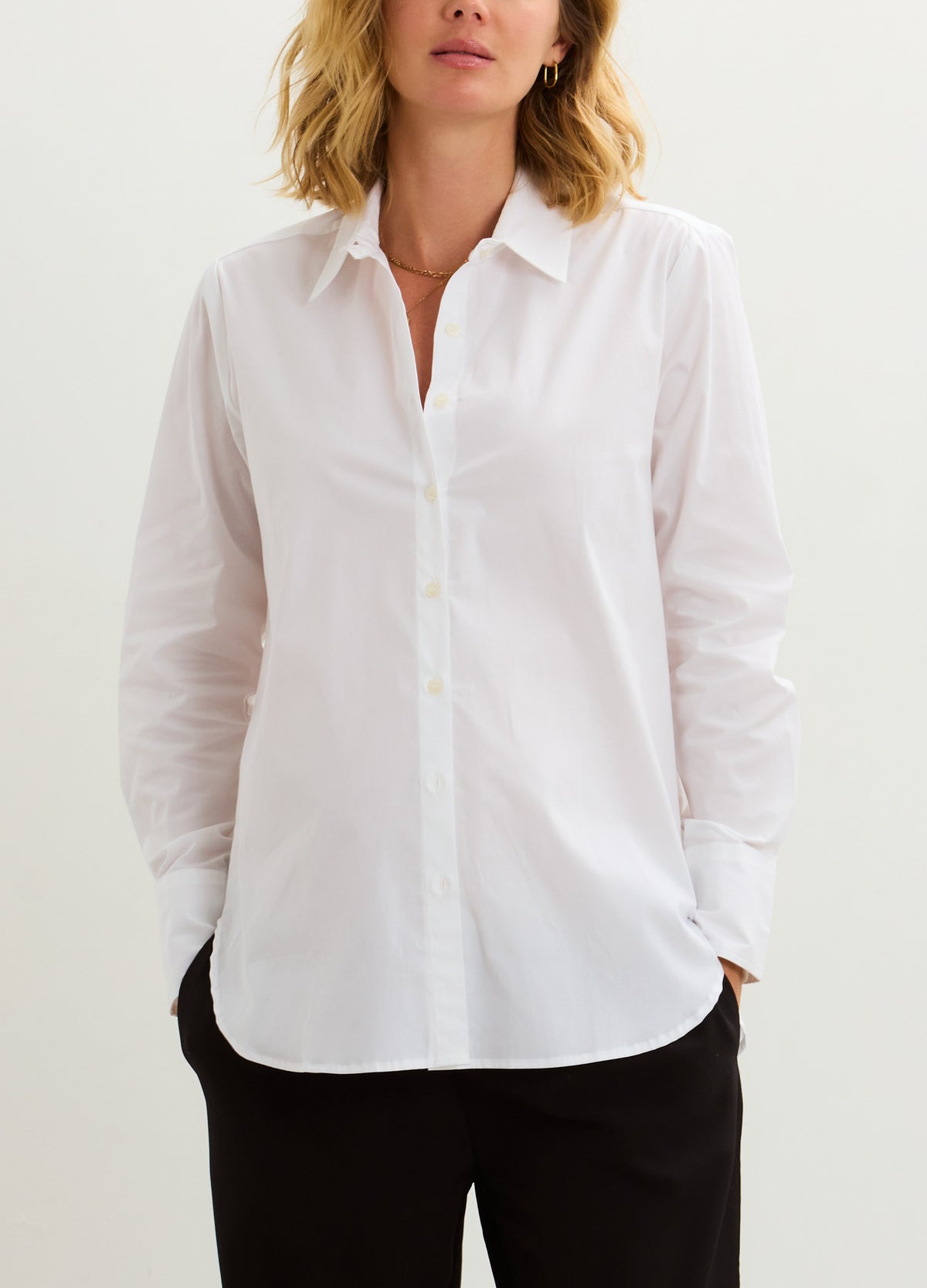 White long-sleeve maternity buttondown shirt with classic collar, tailored fit for pregnant shape.