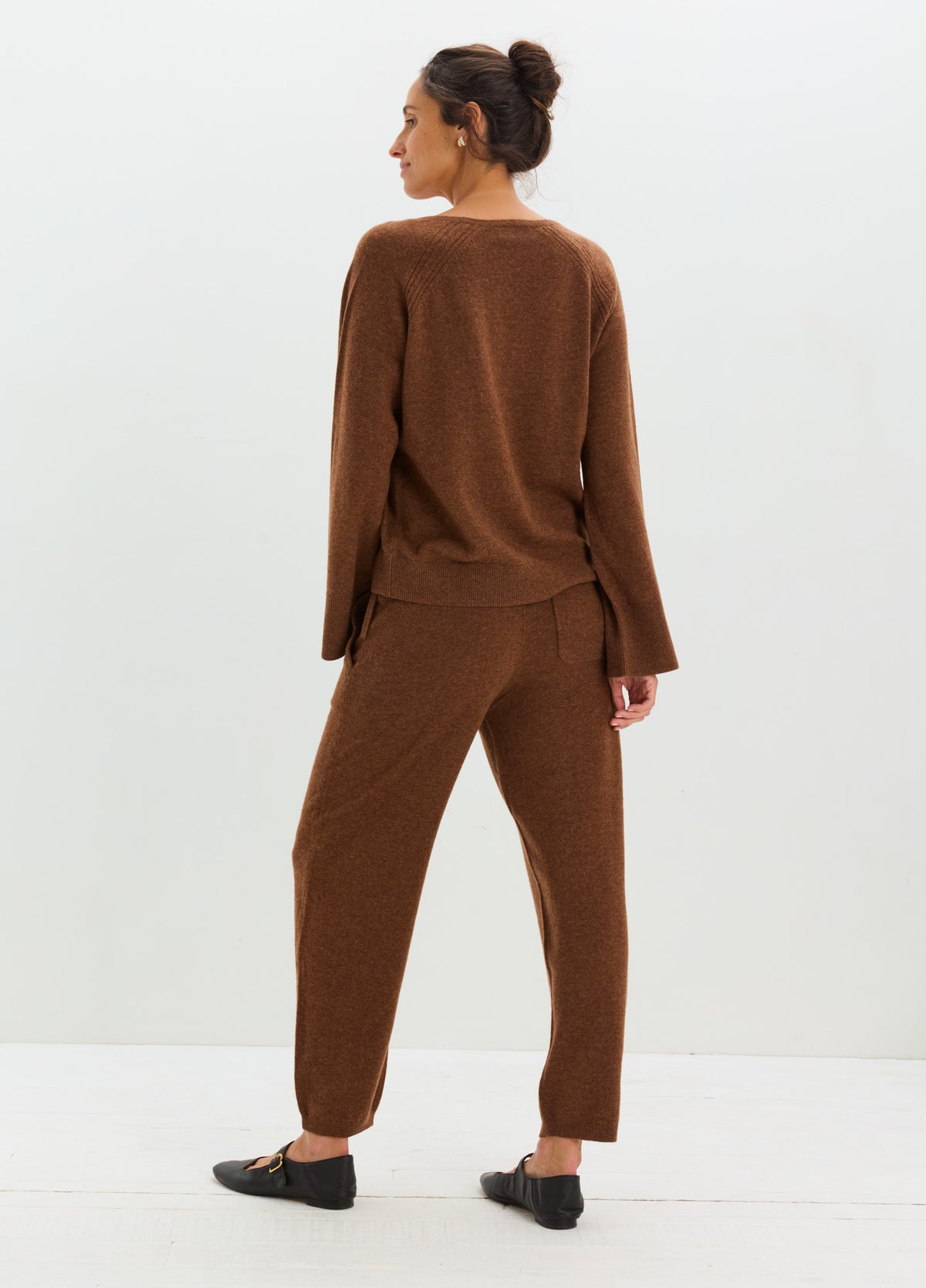 Brown cashmere cardigan with a relaxed fit, paired with matching tapered pants.