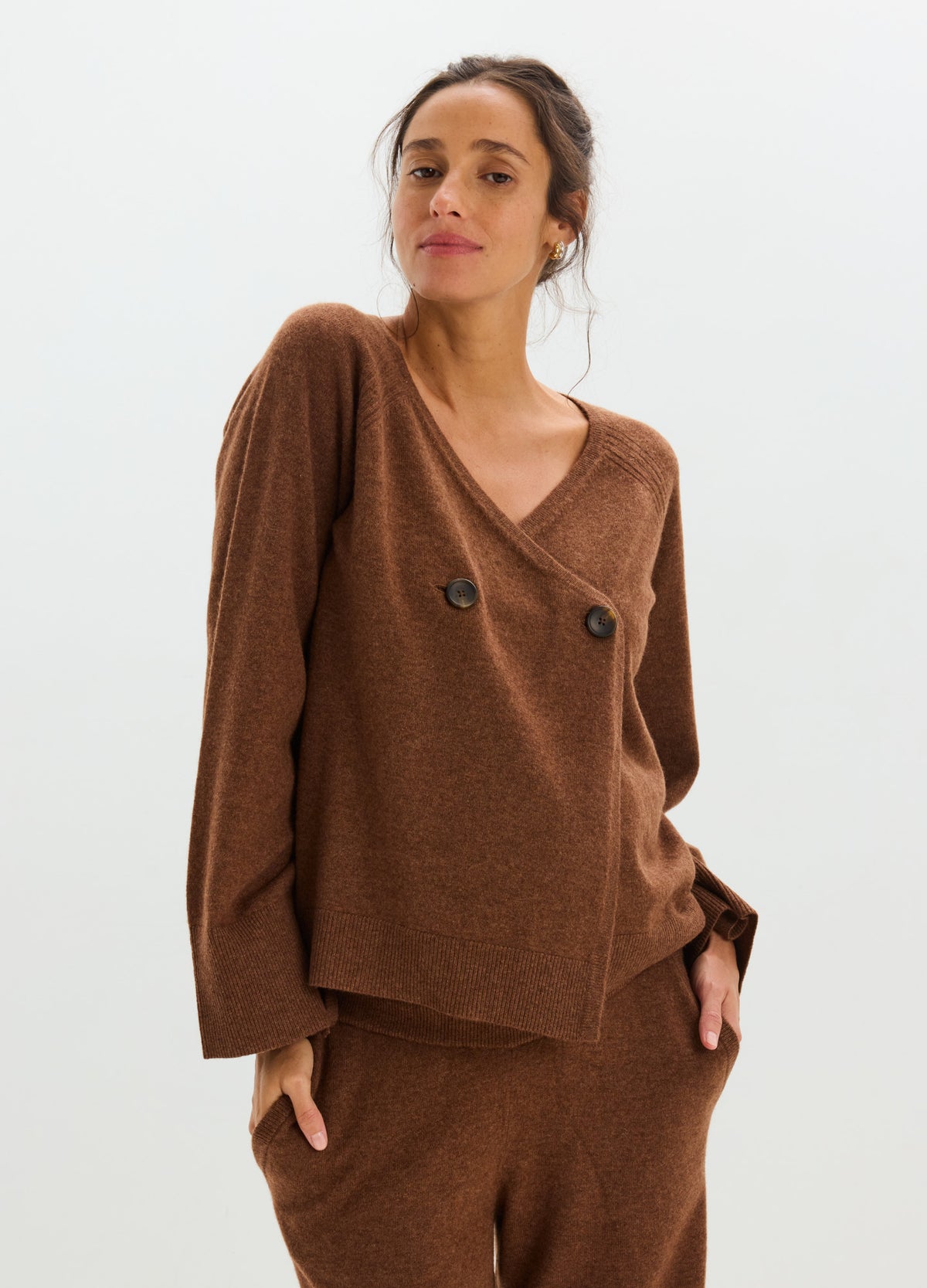 Brown cashmere cardigan with a deep V-neck, double-breasted buttons, and relaxed long sleeves.