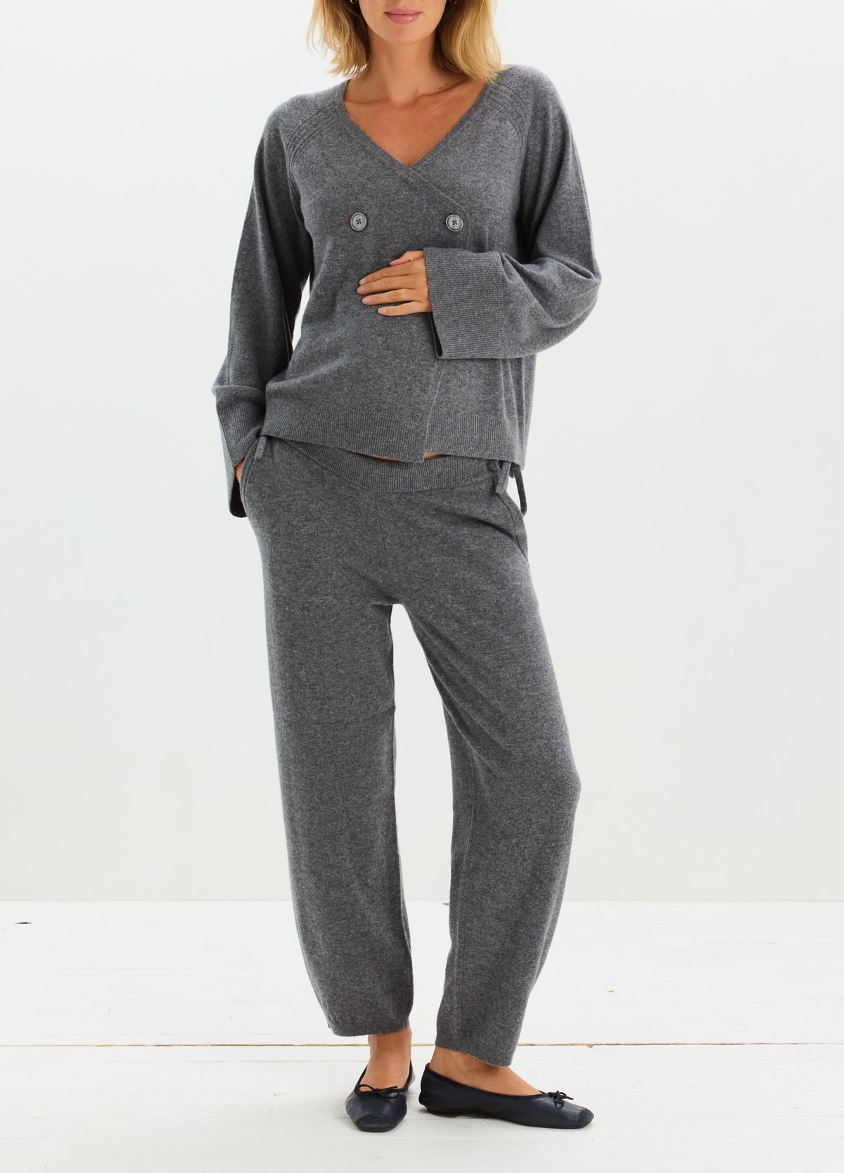 Charcoal gray cashmere cardigan with button front and matching relaxed-fit pants, styled as a cozy set.