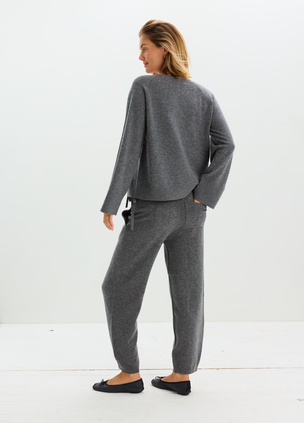 Charcoal gray cashmere cardigan with a relaxed fit, shown with matching jogger pants.