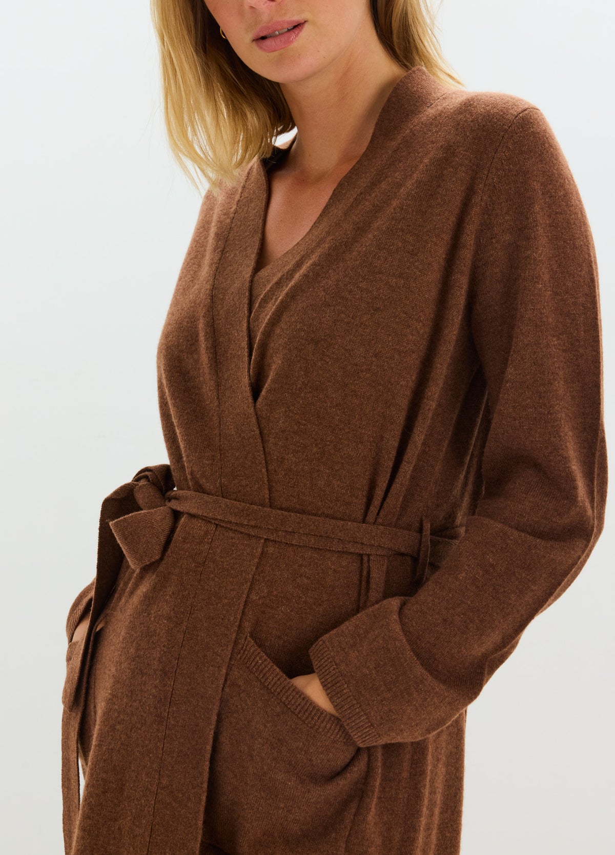 Soft brown cashmere robe with a wrap front, long sleeves, deep pockets, and a self-tie belt.