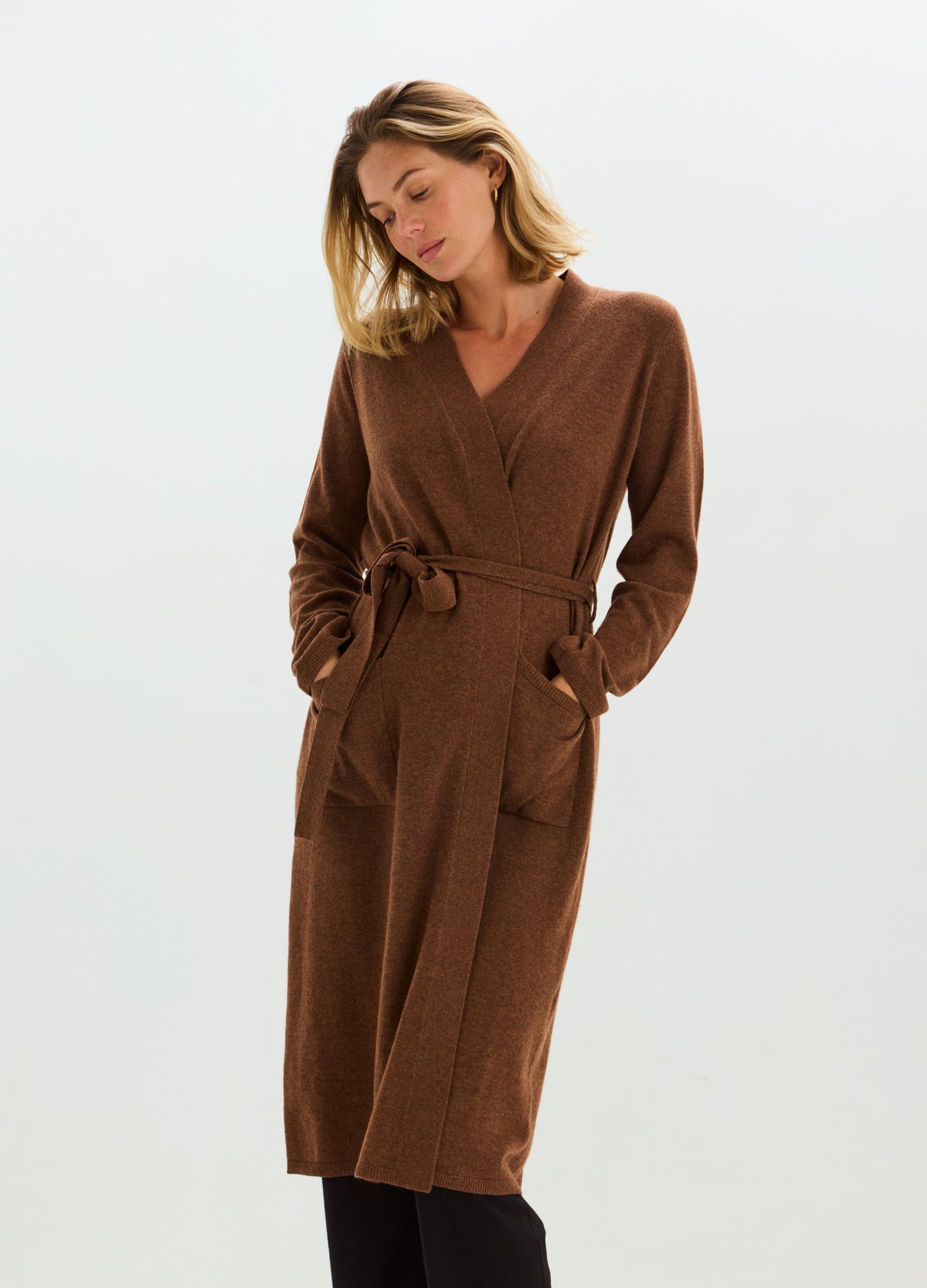 Brown cashmere wrap robe with a V-neck, long sleeves, tie belt, and roomy patch pockets.