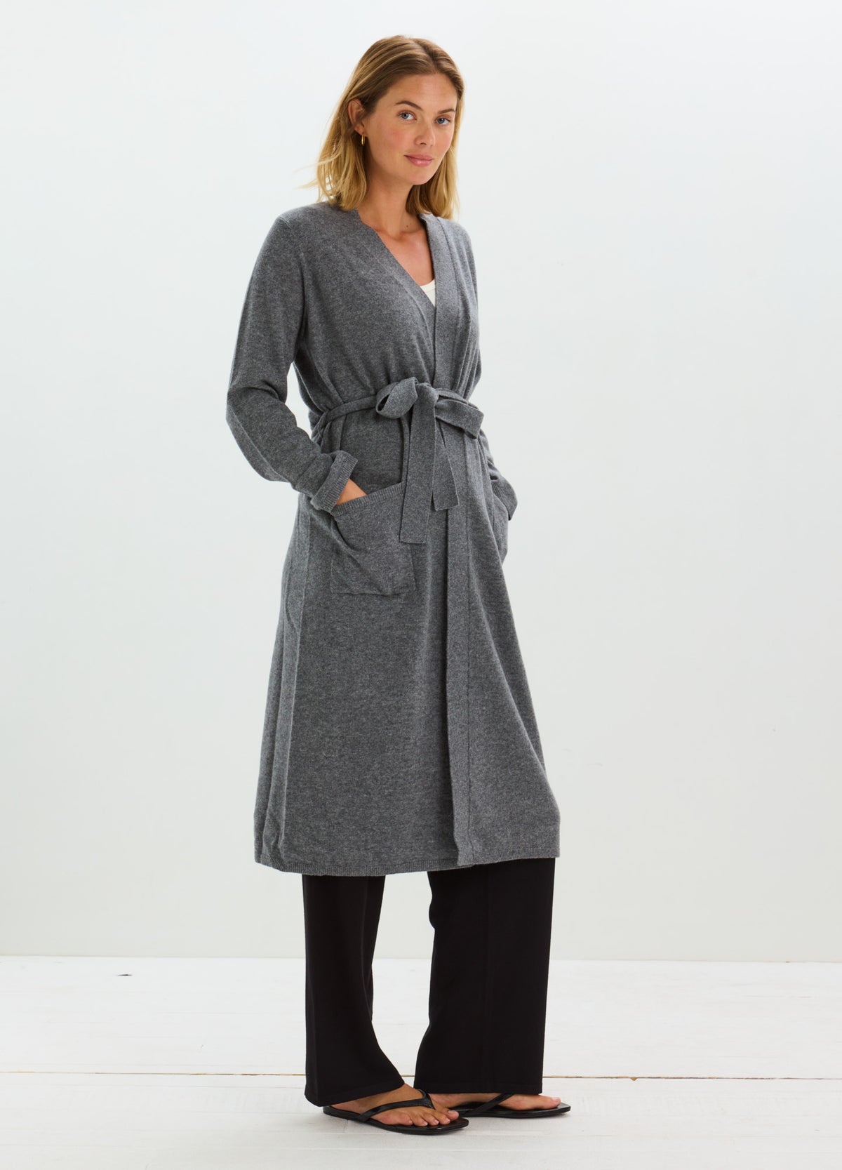 Charcoal gray cashmere robe with a shawl collar, long sleeves, tie belt, and roomy pockets.