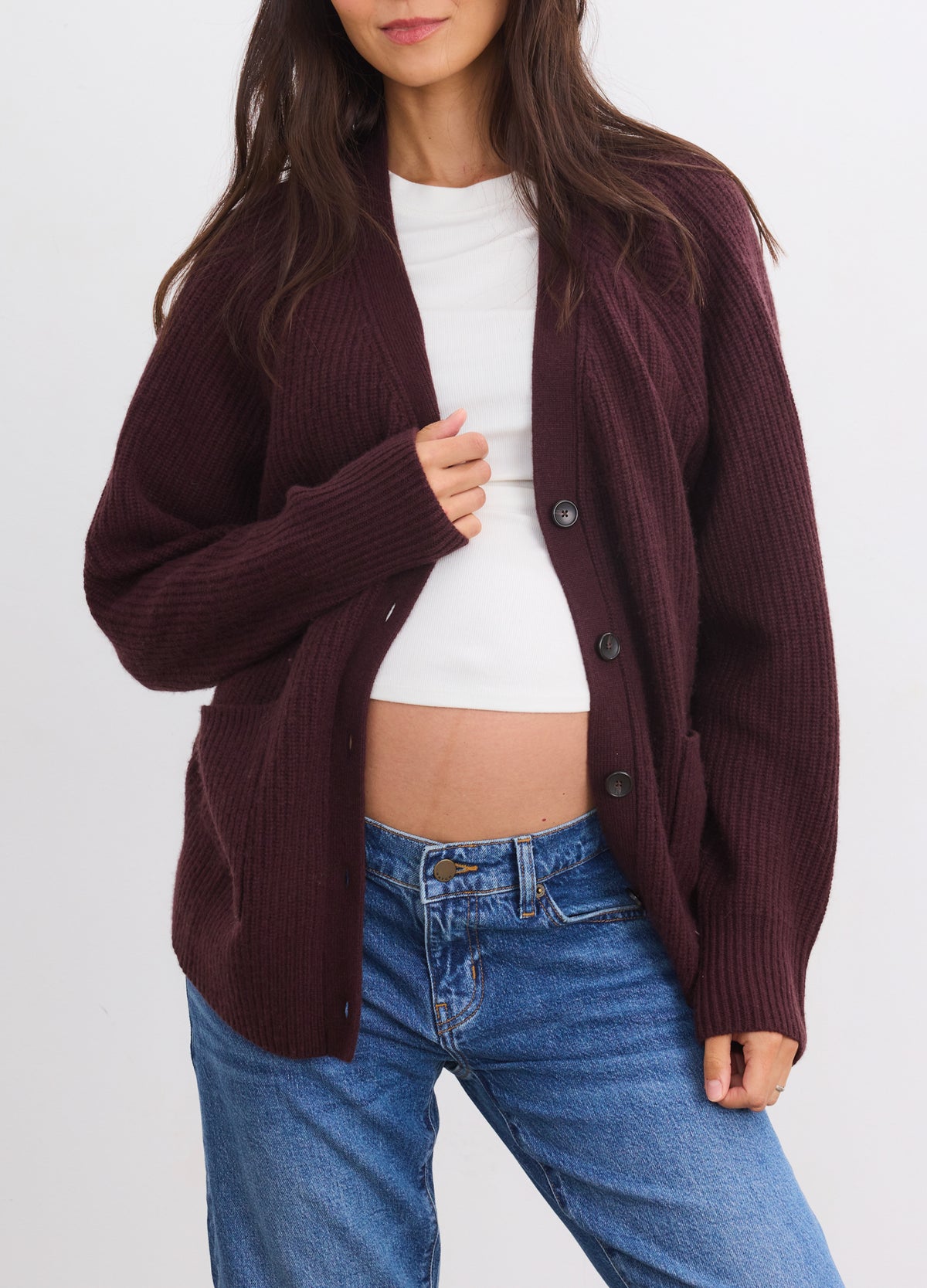 Espresso cashmere cardigan over white top, cozy maternity knit for pregnant women.