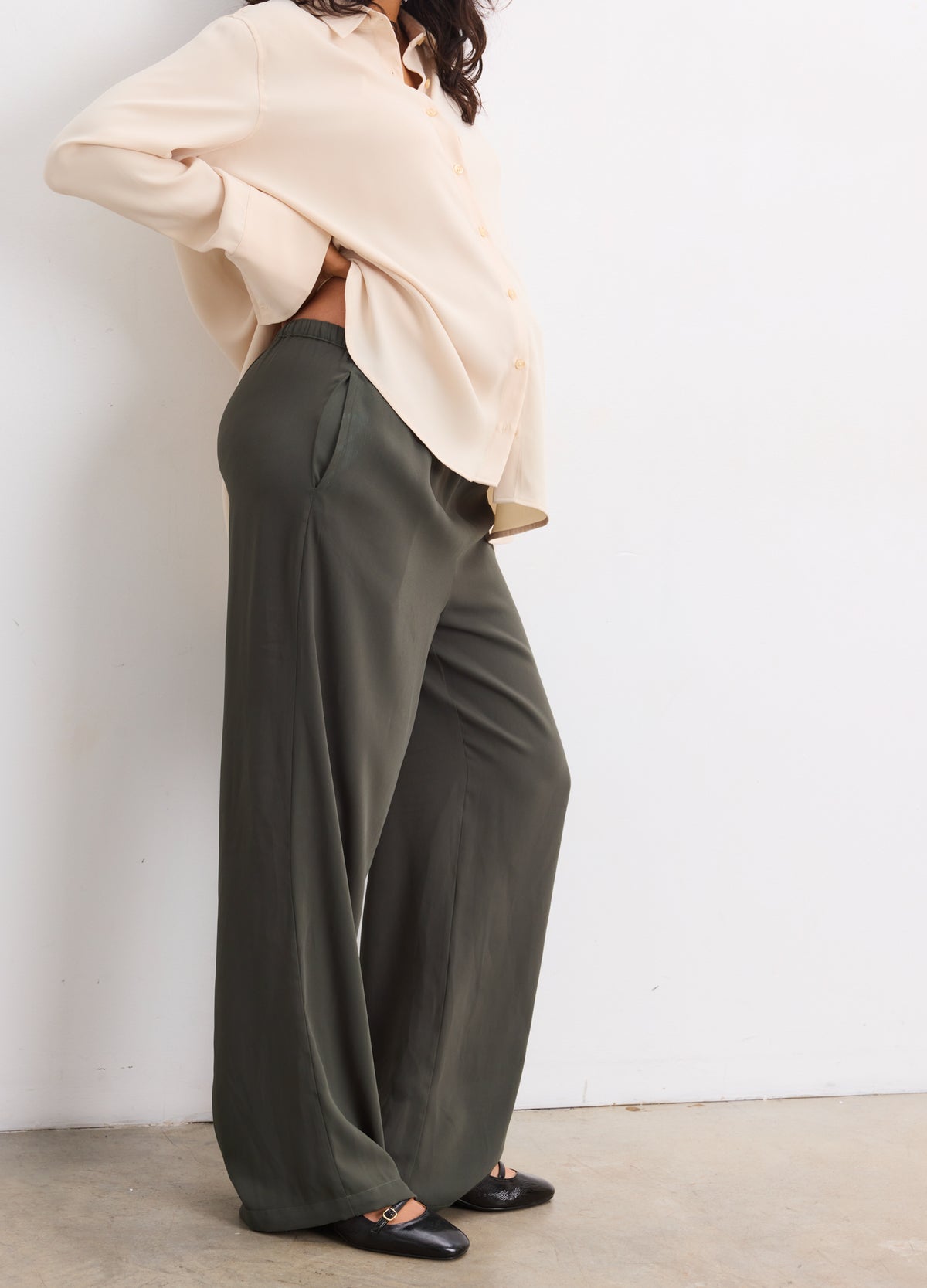 Olive green wide-leg maternity pull-on pants with a drapey fit and elastic waist.