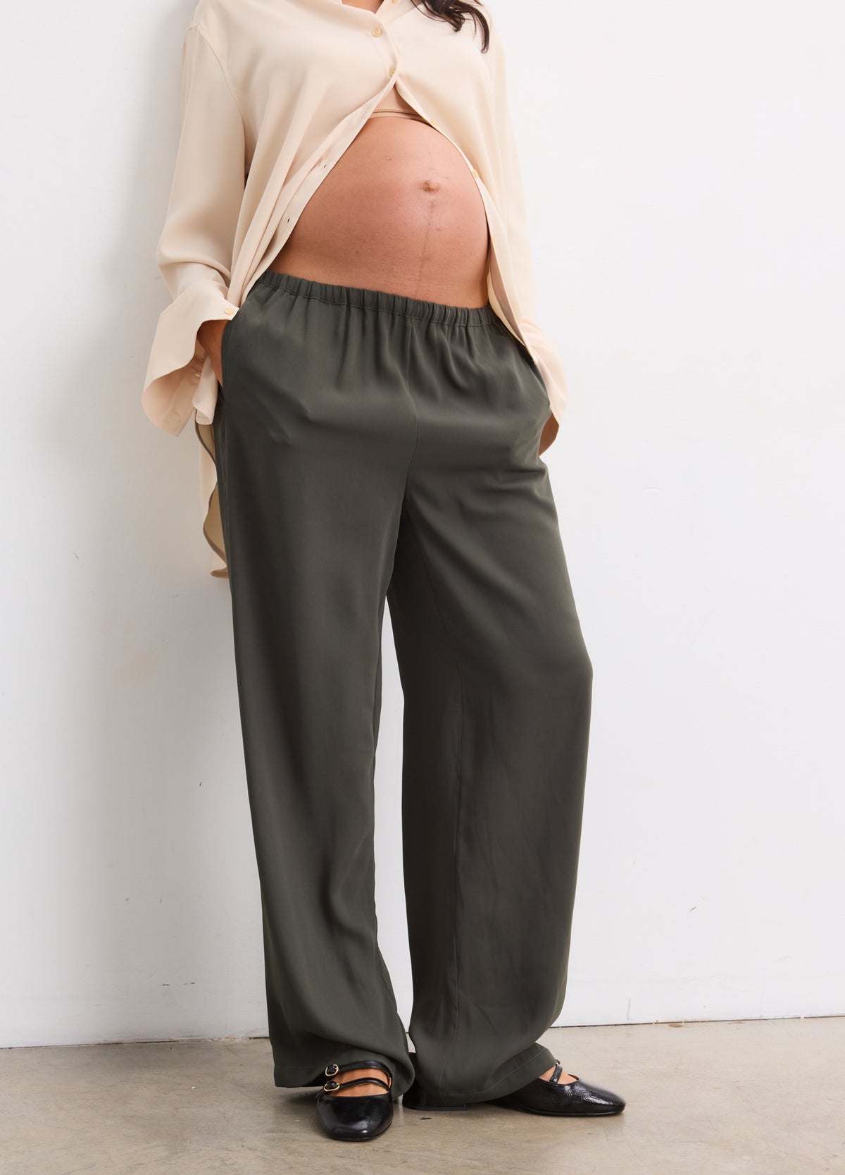 Maternity pull-on pants in basil green with elastic waistband and relaxed drapey fit for pregnant comfort.