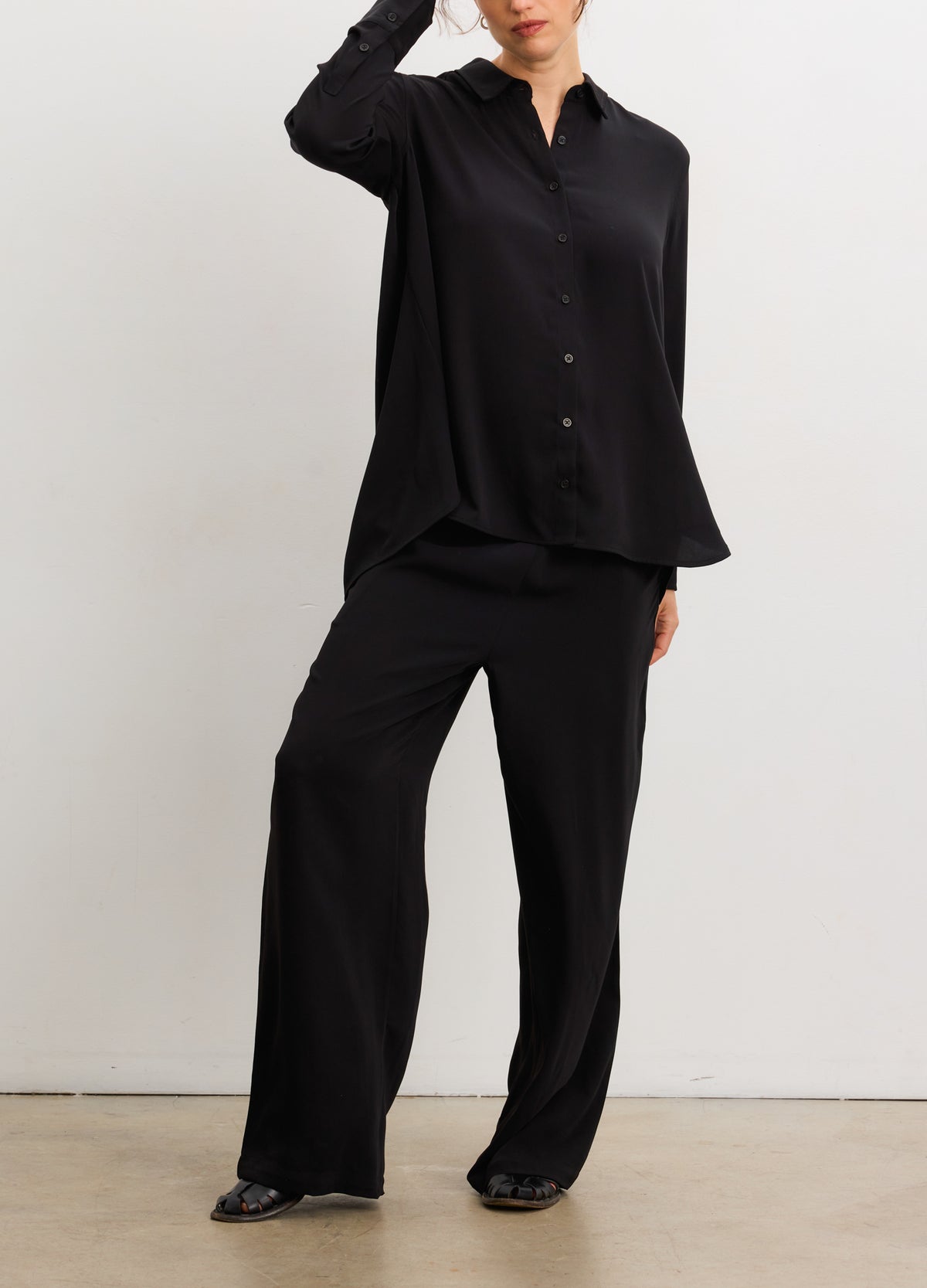 Black drapey maternity pull-on pants with relaxed fit, styled for pregnant women.