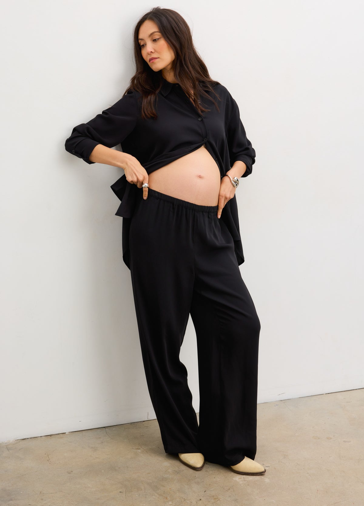 Black wide-leg drapey maternity pull-on pants with elastic waistband and soft fabric.