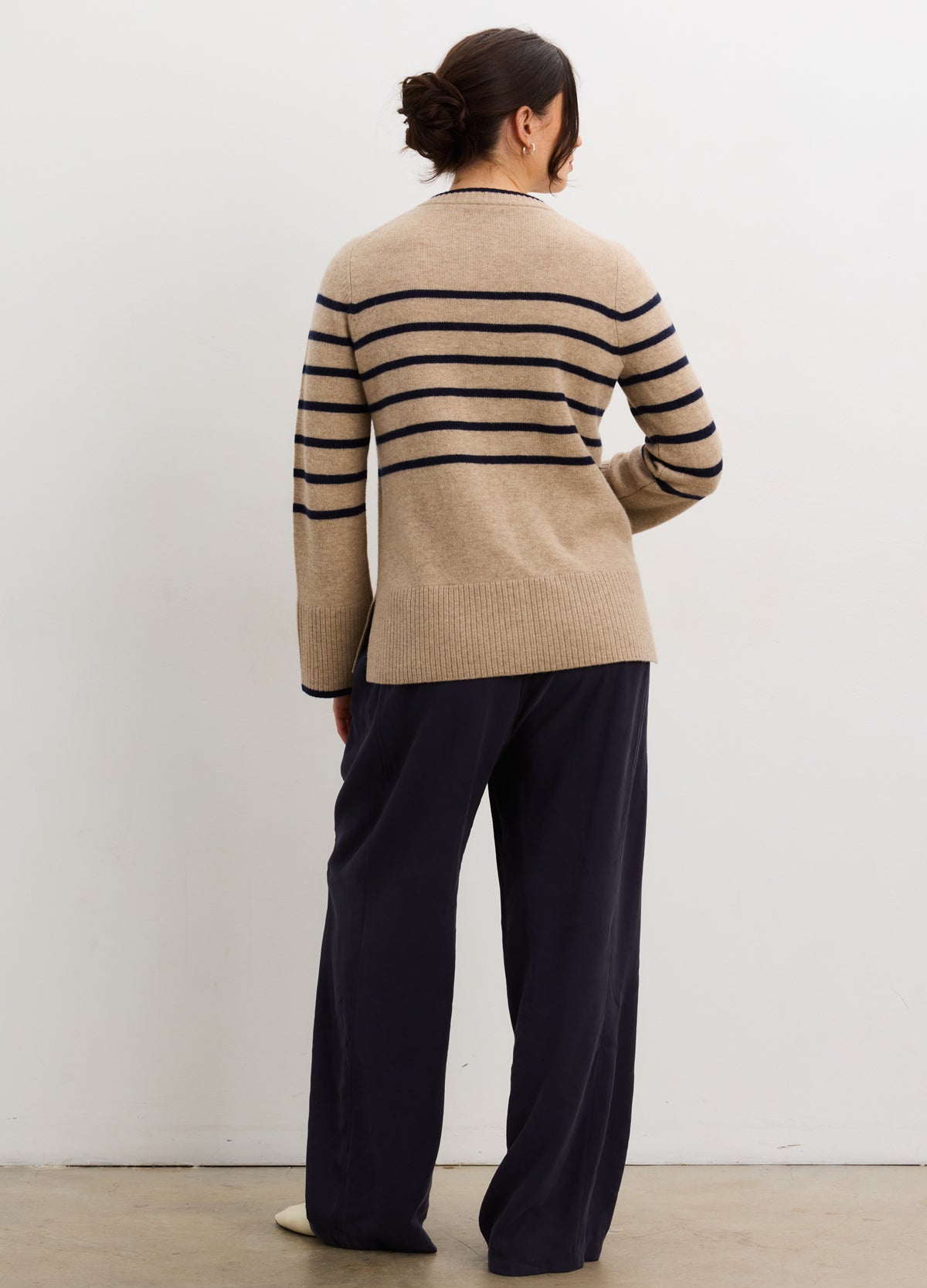 Beige cashmere cardigan with black horizontal stripes and relaxed fit, styled for maternity wear.