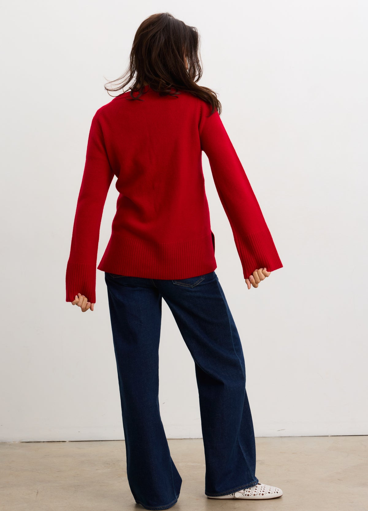 Red long-sleeve maternity cardigan with relaxed fit and ribbed cuffs, paired with dark wide-leg pants.