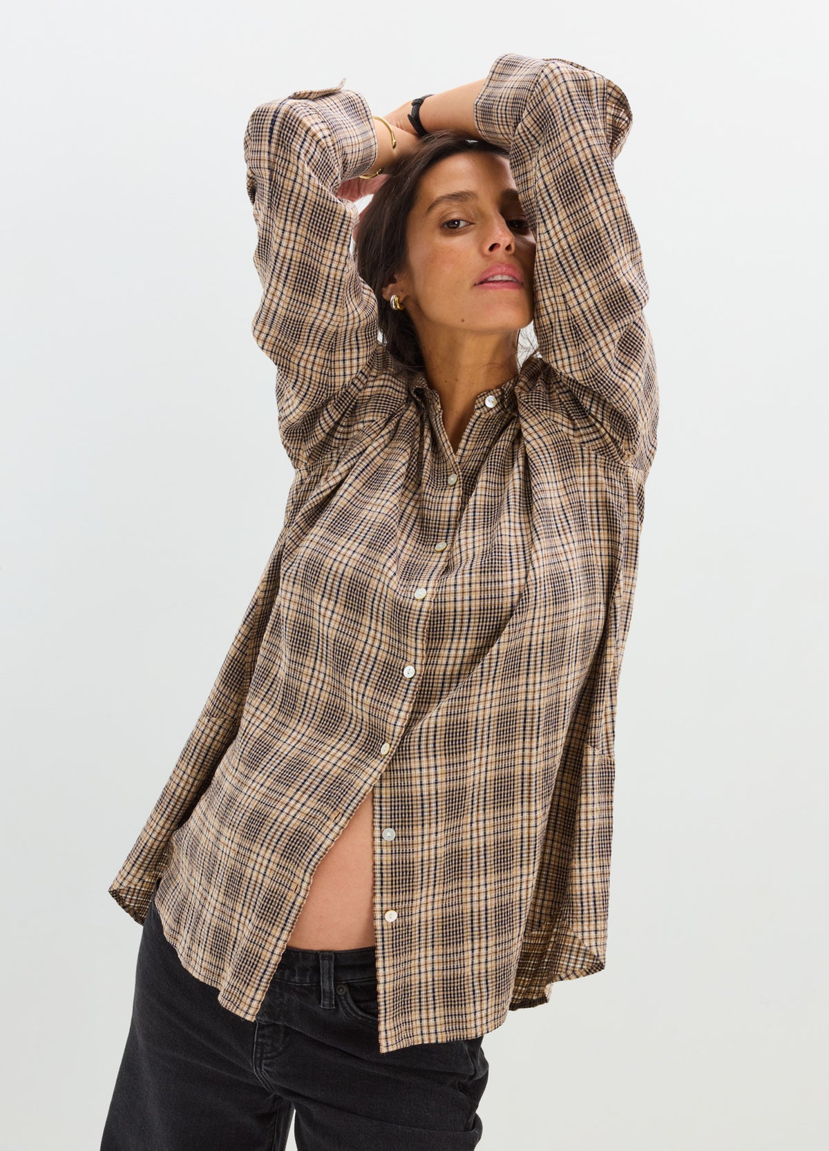 Loose-fit maternity buttondown shirt in brown plaid with long sleeves and curved hem.