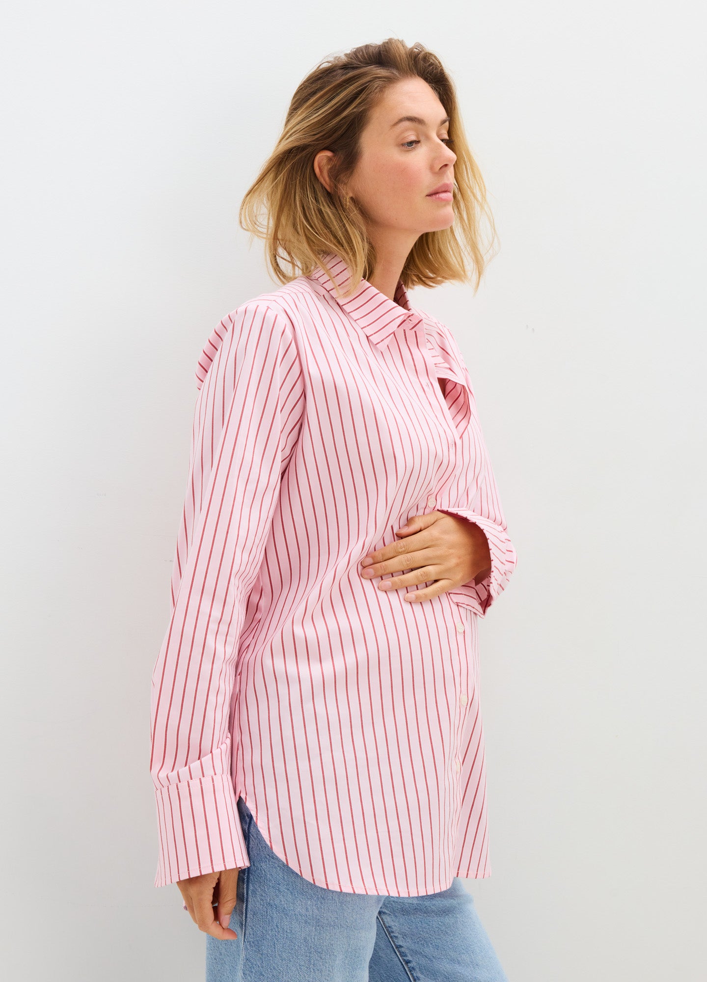 Pink and white vertical striped long-sleeve maternity button-down shirt with relaxed fit.