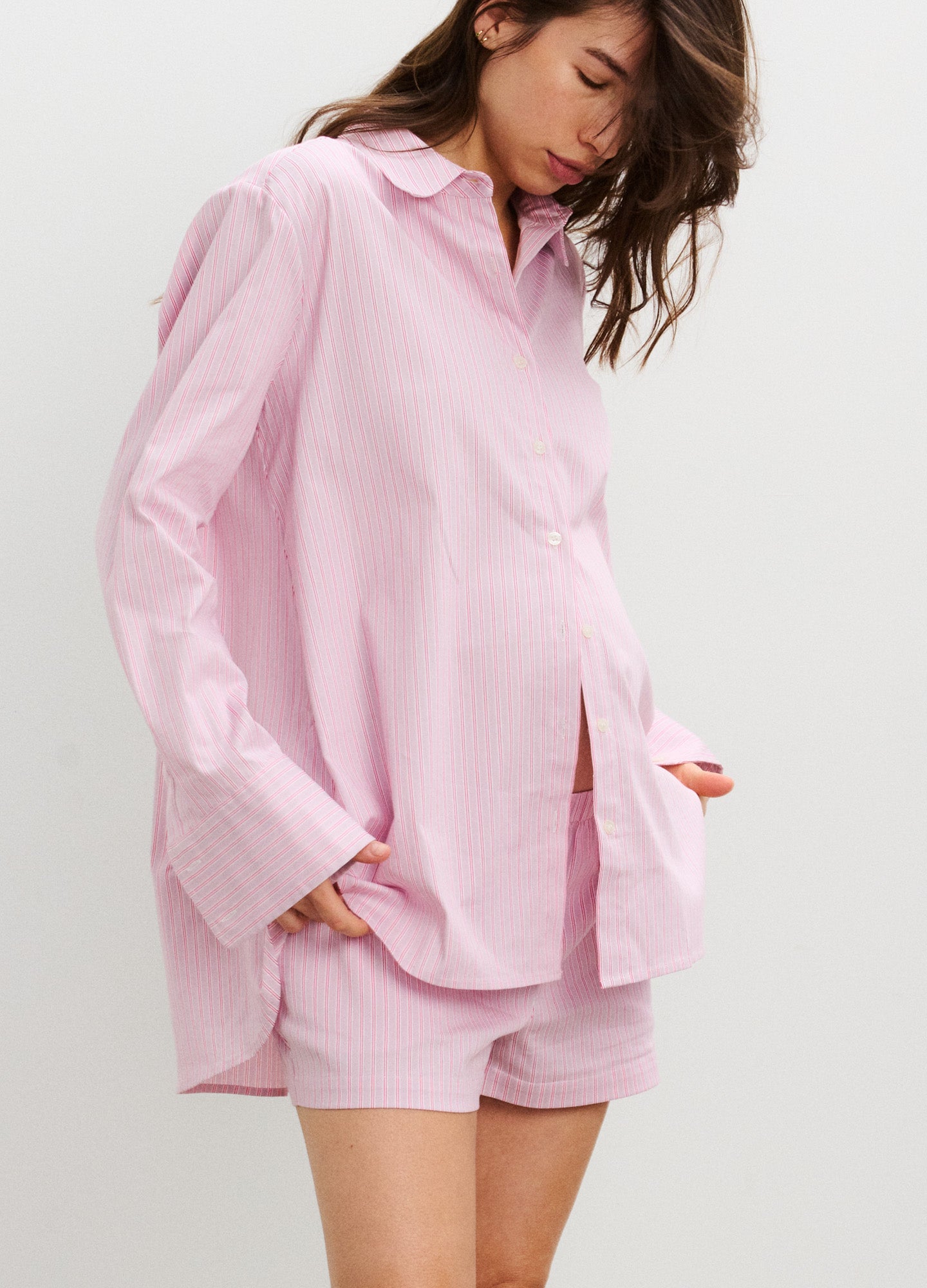 Light pink long-sleeve maternity buttondown shirt with relaxed fit and subtle collar.