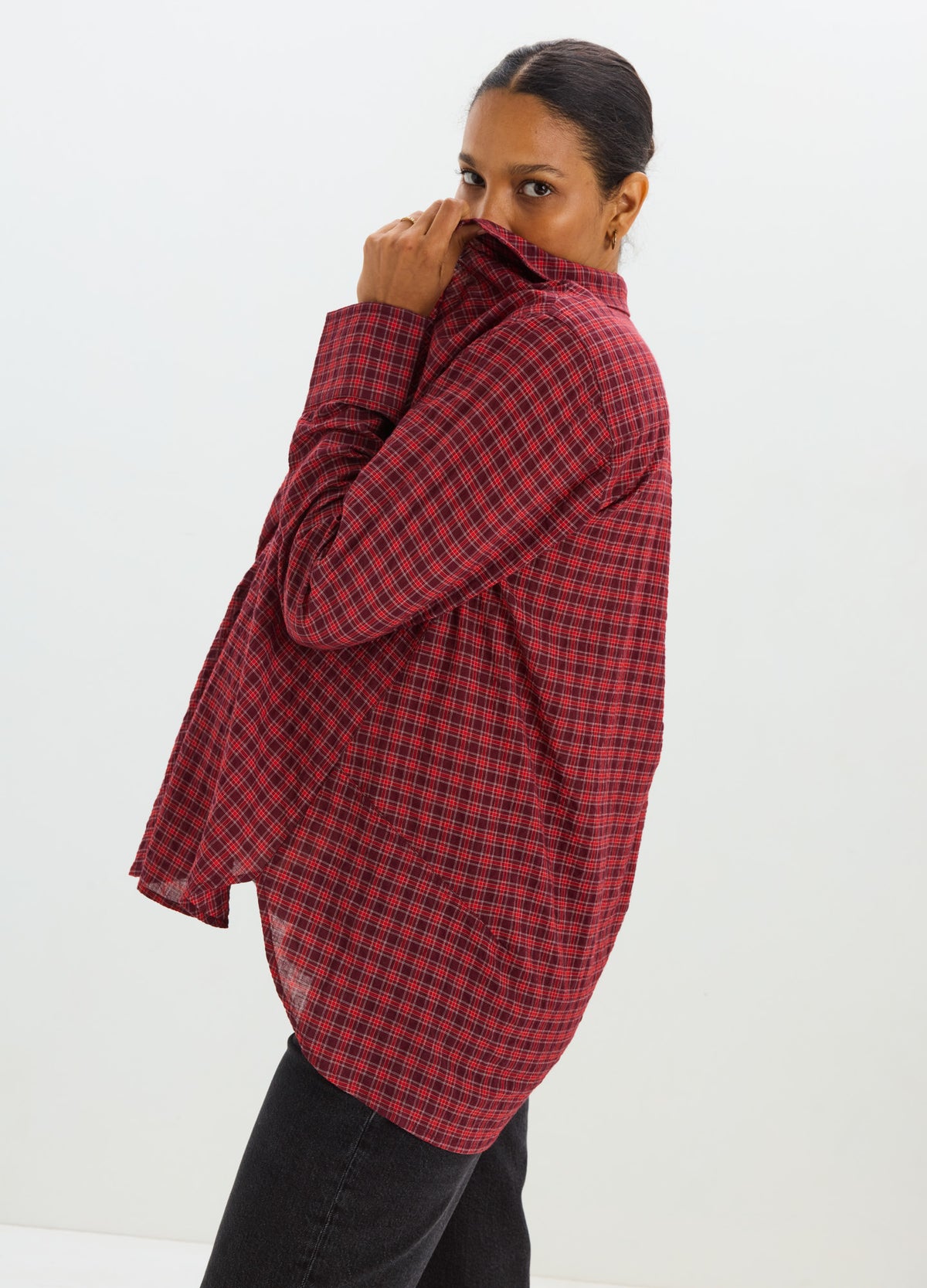 Red and black checkered maternity button-down shirt with long sleeves and relaxed fit.