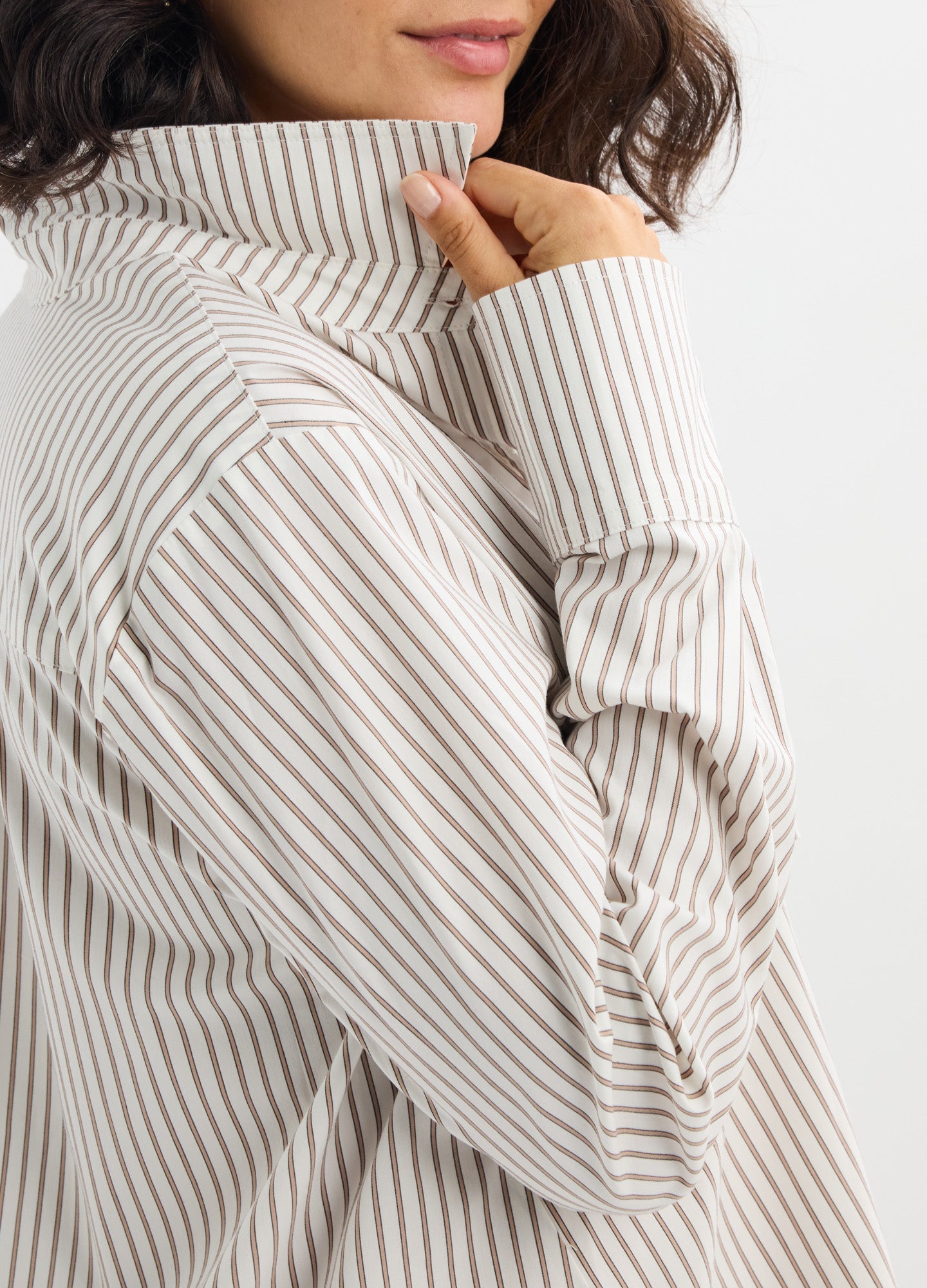 Striped beige and white maternity button-down shirt in soft fabric with long sleeves and high collar.