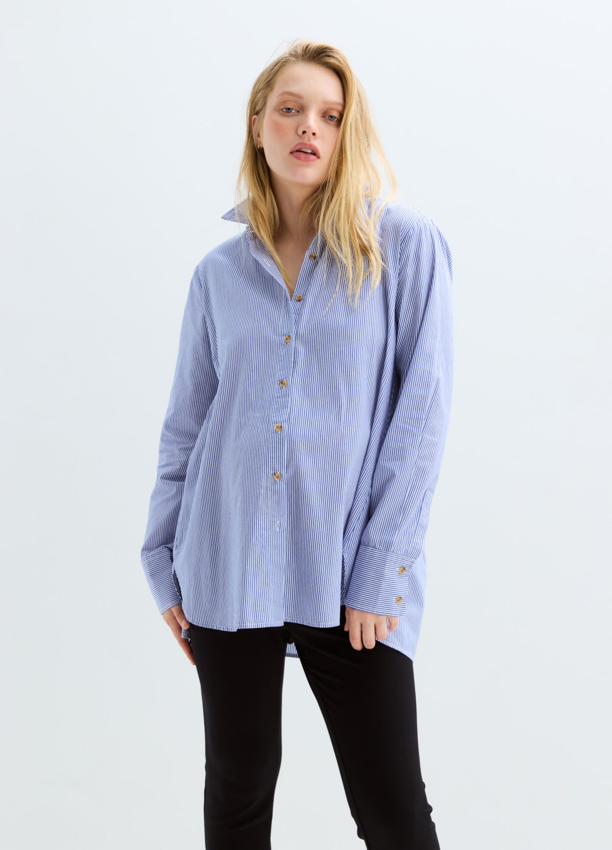 Light blue long-sleeve maternity buttondown shirt with front buttons and relaxed fit.